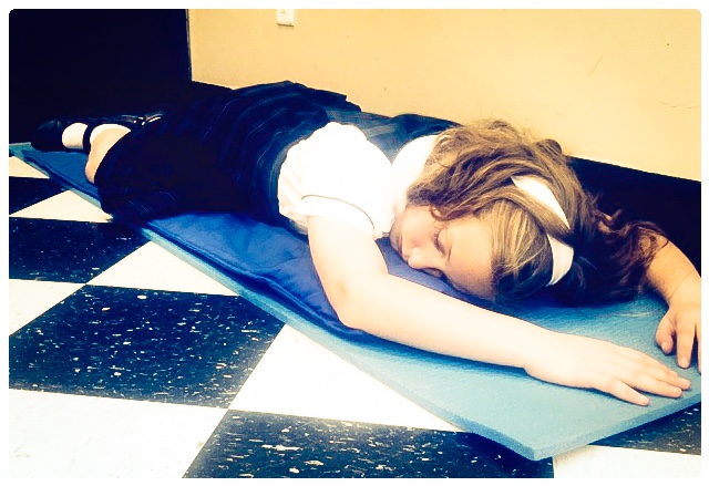 When Miss Naaden sees that Mathilda is due for a nap, she instructs her to roll out her mat. Quietly and without disrupting the class, Mathilda sleeps for forty minutes then slips back into the lesson. Staying in the room makes her feel safe and not so "different." Her classmates are accepting of the fact she needs to sleep every day.