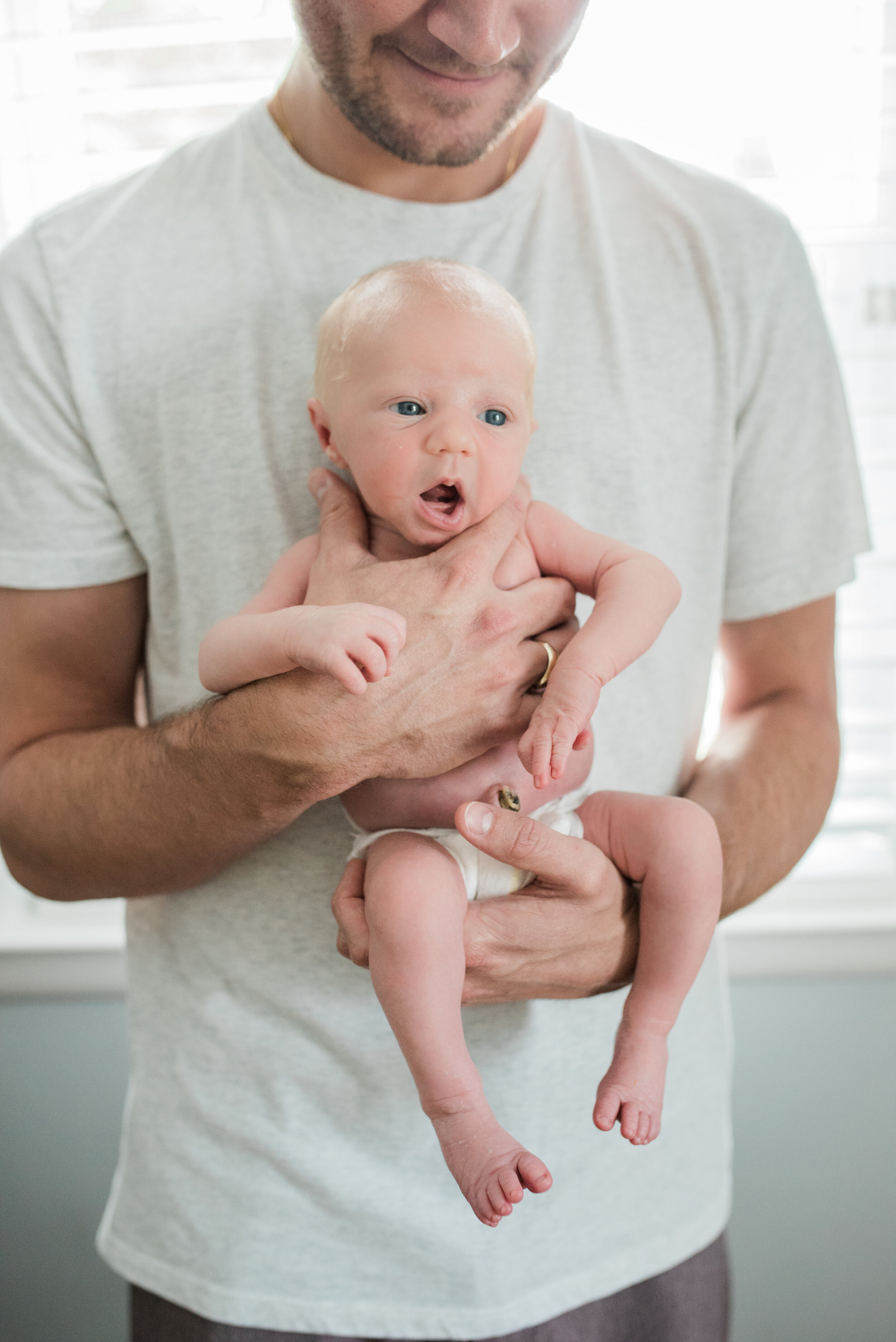 baby held by father, Penny Lane Lifestyle Photography, Natural Light Photographer