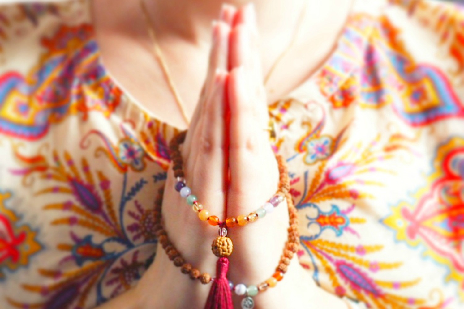 praying hands and mala beads