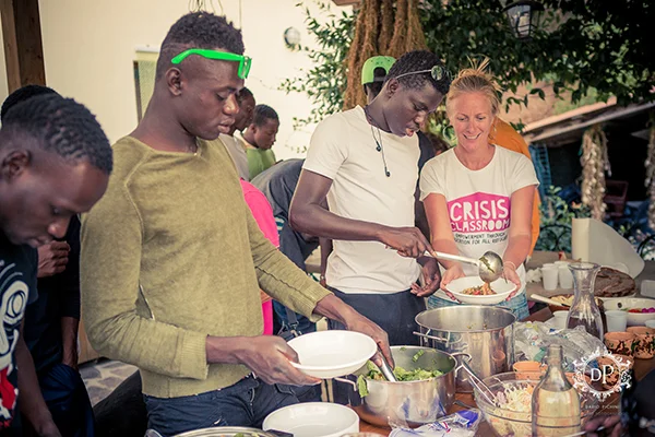 Kate and refugees share a meal in a co-created activity.