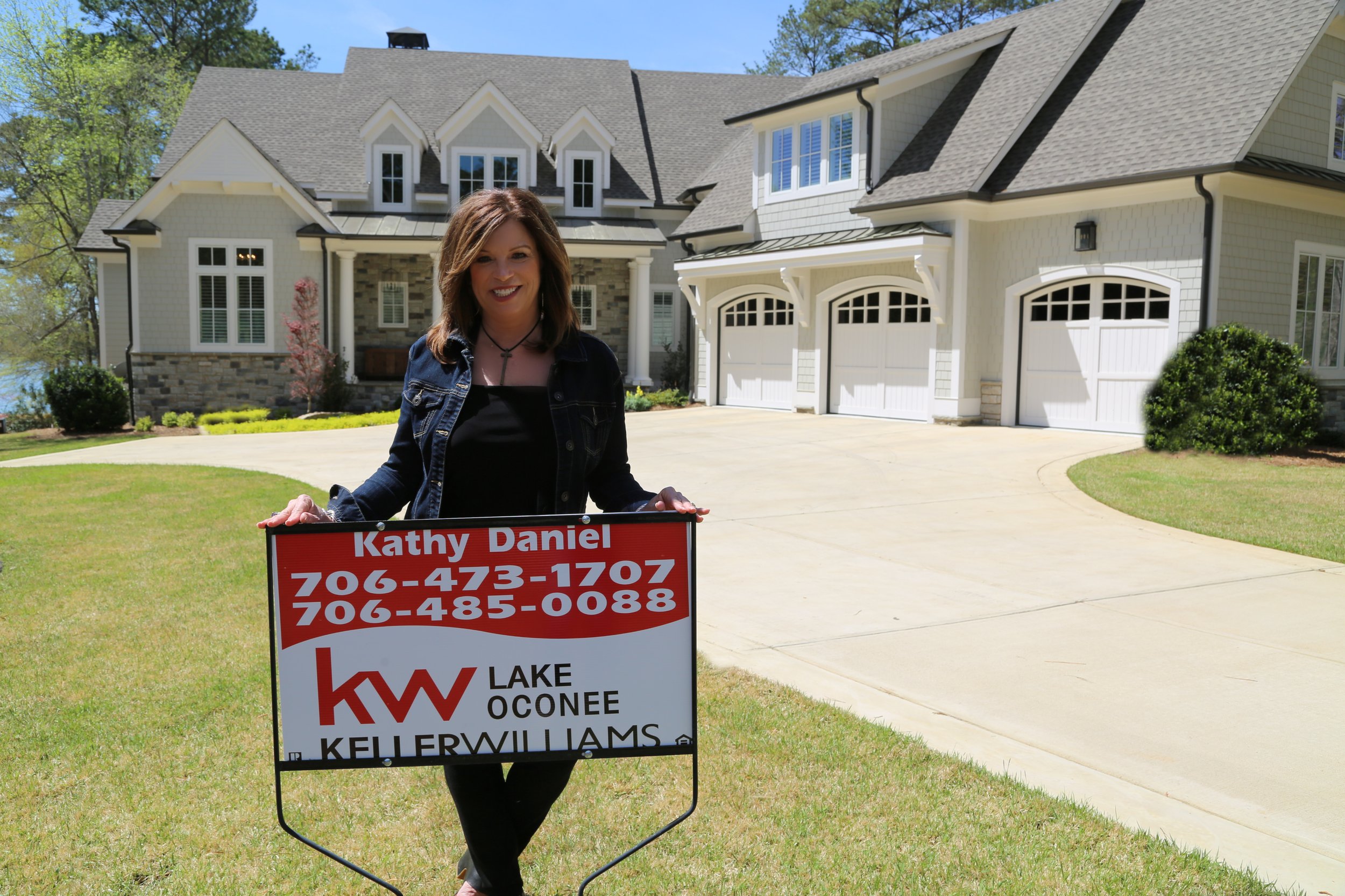 Kathy Photo with sign in front yard of 1221 Big Water Circle (2).jpeg