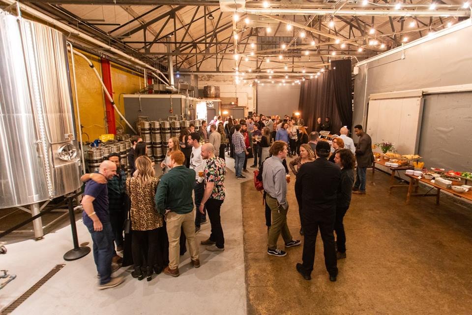  The Brewery can accommodate up to 75 people with direct views of our tanks, fermenters, and more. This portion of our building features high, vaulted ceilings and unique industrial charm. 