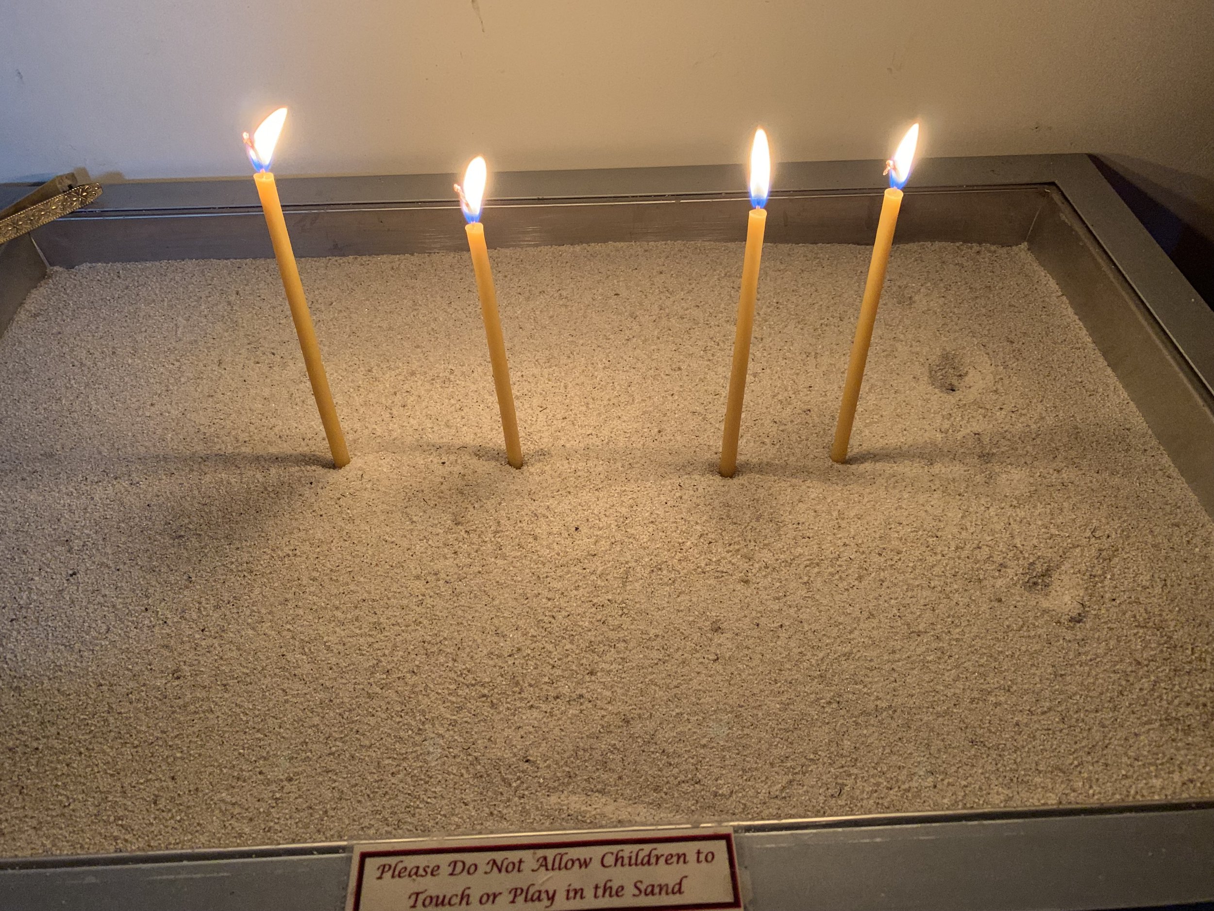 Candles contribute to the ambience inside the church. Photo by Julia Duin.