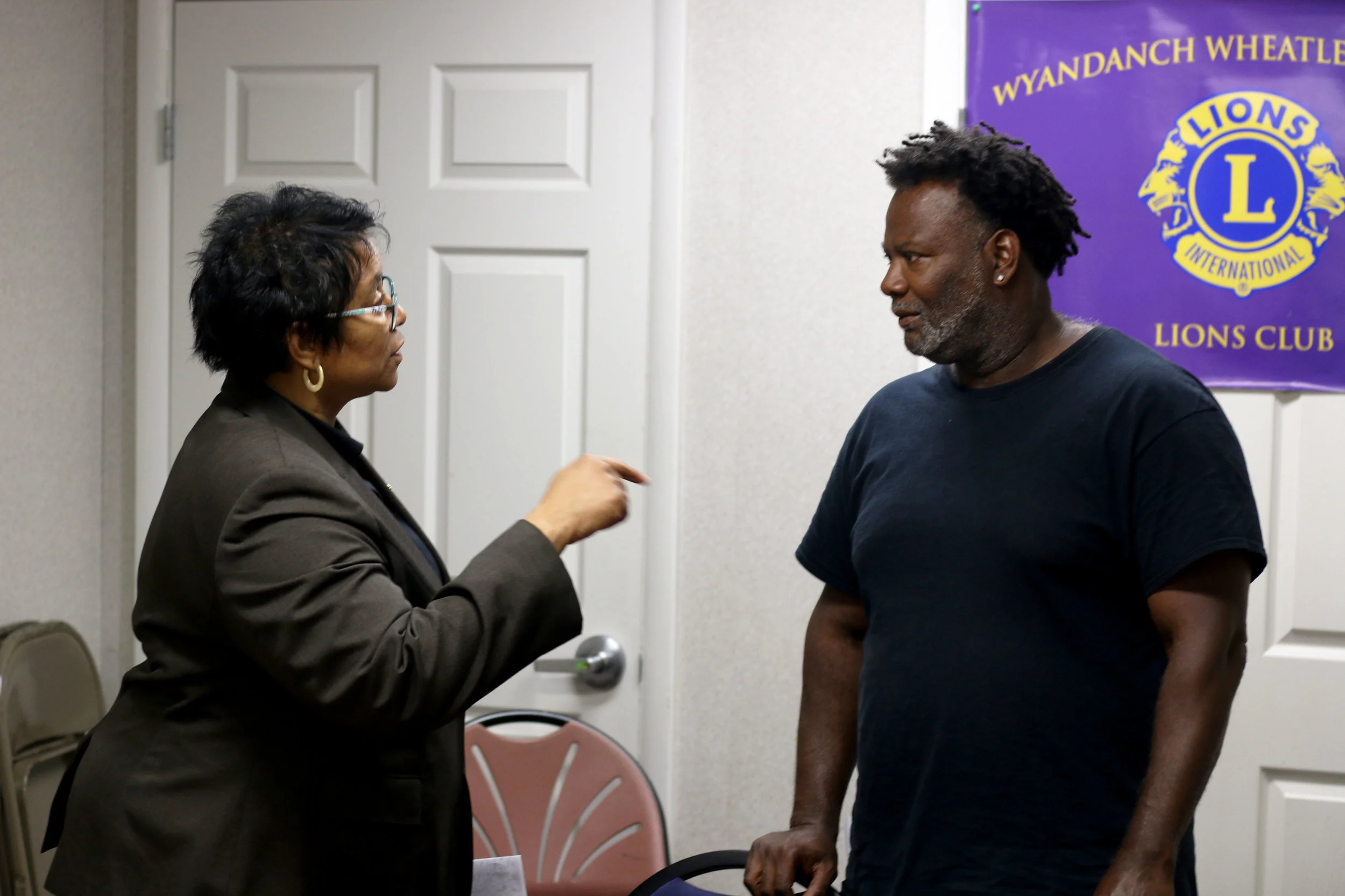 Mention-Lewis speaks to Yazid Owens, a facilitator of the Wyandanch meeting. Photo by Micah Danney.