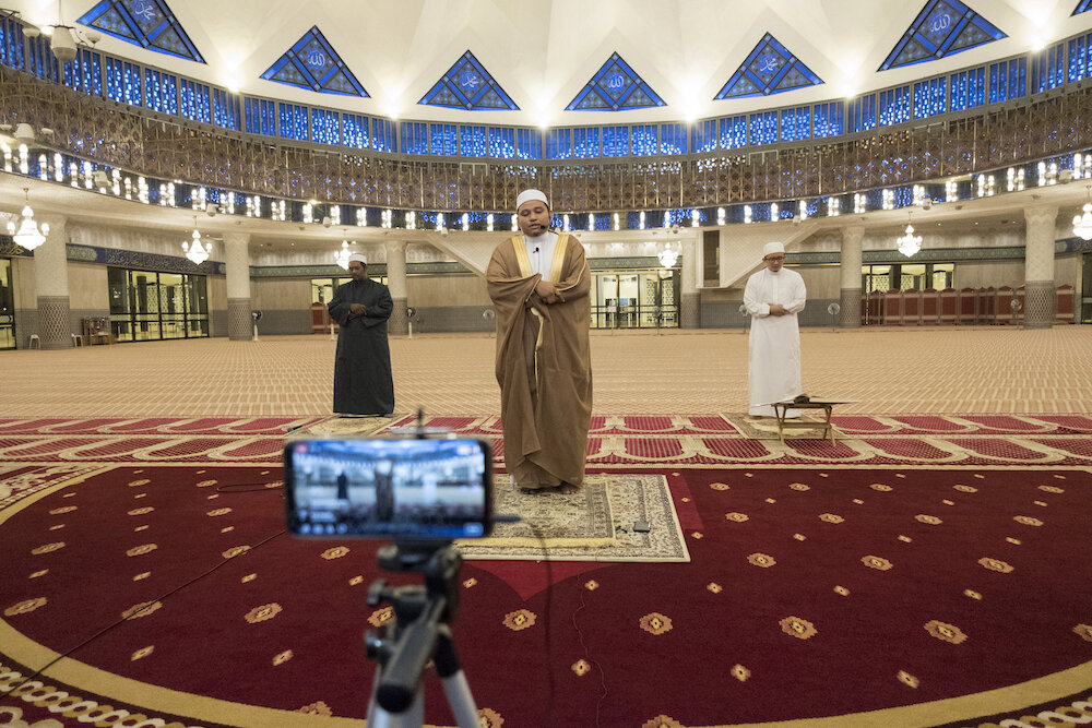  An imam and his assistants perform the Tarawih prayer at the National Mosque in Kuala Lumpur on April 24. The prayer was broadcasted live. Photo by Alexandra Radu. 