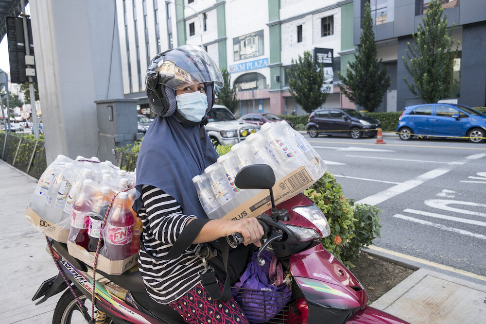  A woman drives a fully loaded motorbike after shopping ahead of the Eid al Fitr celebration in Kuala Lumpur. Photo by Alexandra Radu. 