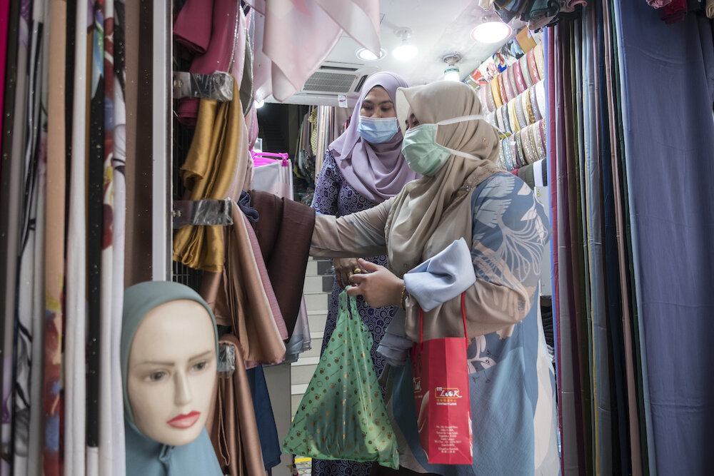  Women shop for new head scarves ahead of the Eid al Fitr celebration in Kuala Lumpur. Shops were open under certain conditions, with limited numbers of people allowed to shop at the same time and contact tracing. Photo by Alexandra Radu. 