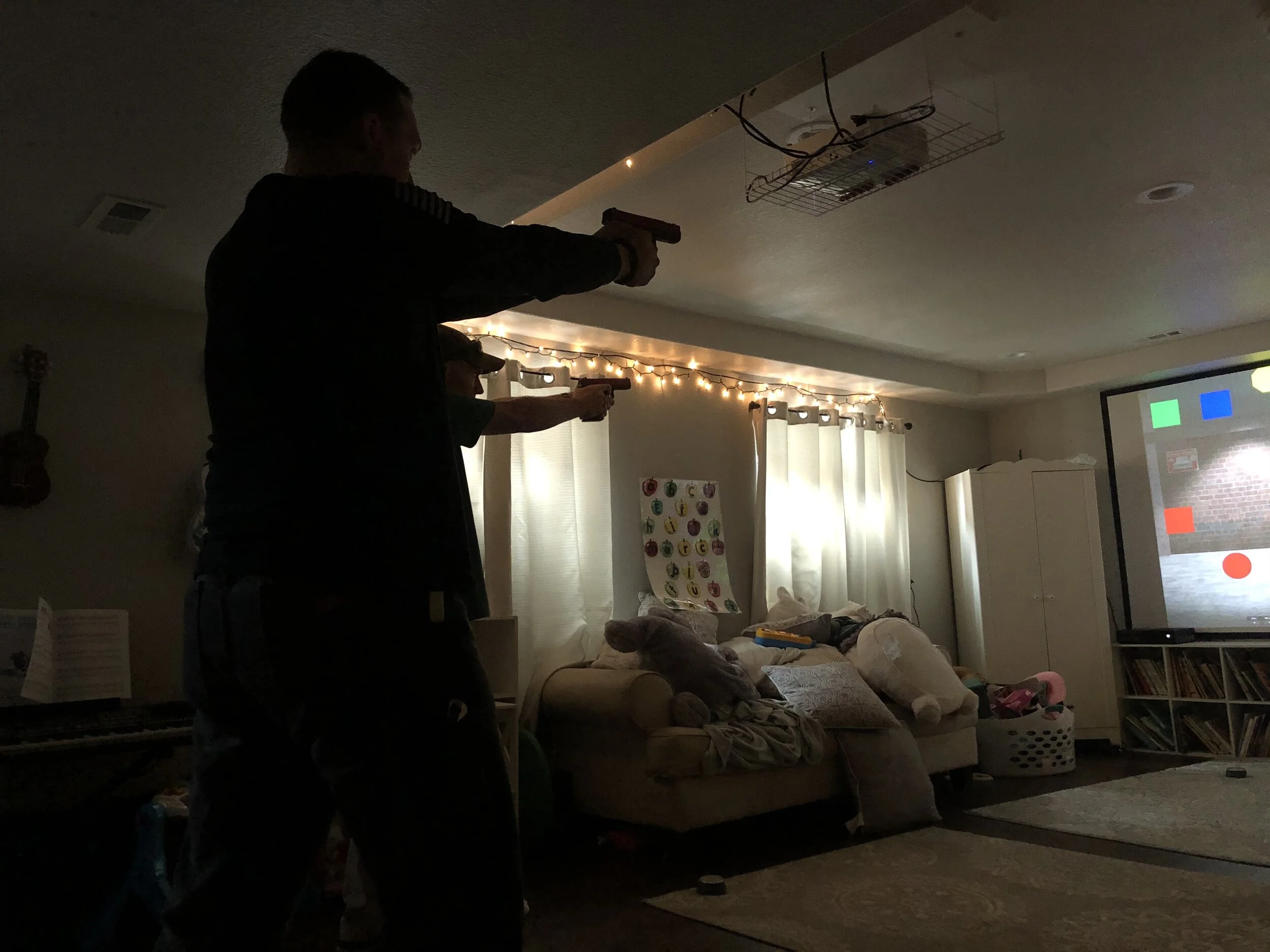 Military, special forces and government intelligence specialists serve in the life safety teams of some churches in the United States. Some members of a church security team in Colorado Springs, Colo., practice their shooting speed and accuracy using a laser beam simulator in a friend’s basement. Photo by Paul Glader.