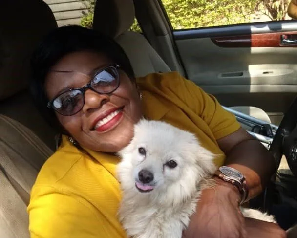 Kwedyo with her dog, Fluffy.