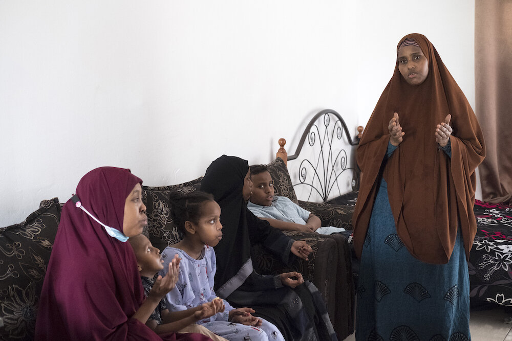  Ridwan prays together with a single mother and her children that she delivered food to on Eid al-Adha. “We are in close contact with our community, so that's how we can know what they need and how we can help,” said Ridwan, who is also in charge of 