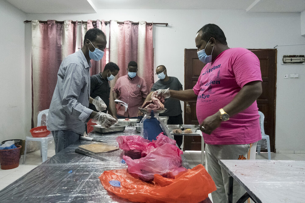  Volunteers at the Somali Refugee Community Centre prepare beef and lamb meat for distribution on Eid al-Adha. Ritual animal sacrifices were performed on behalf of refugee communities by Malaysian refugee support groups, with animals being donated by