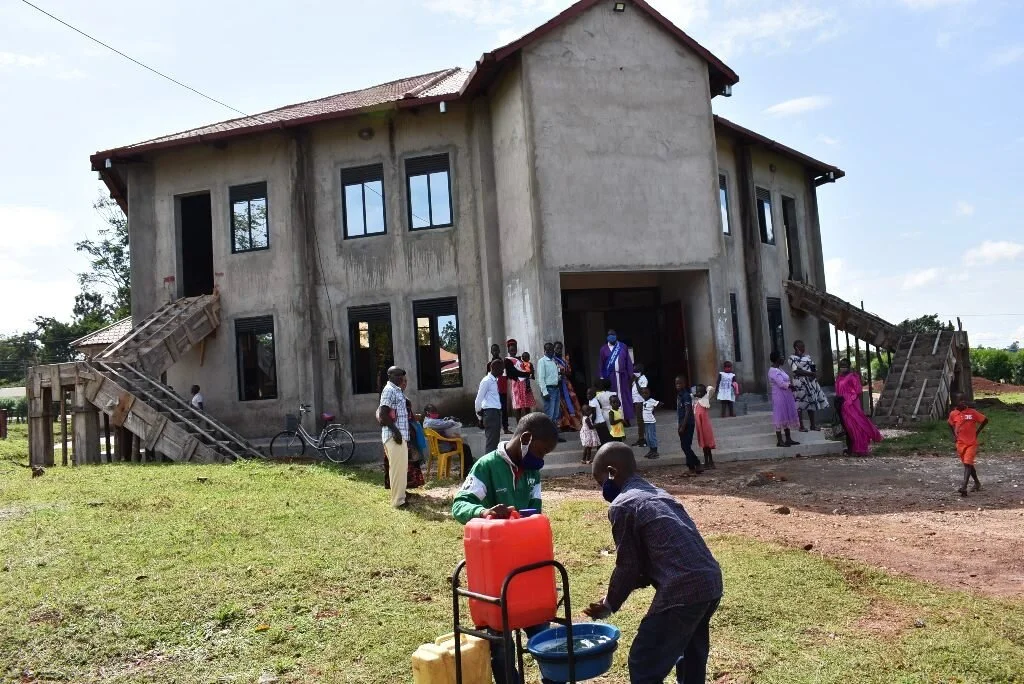 Worshipers wash their hands before entering St. Mark’s Church of Uganda. Photo by John Semakula.