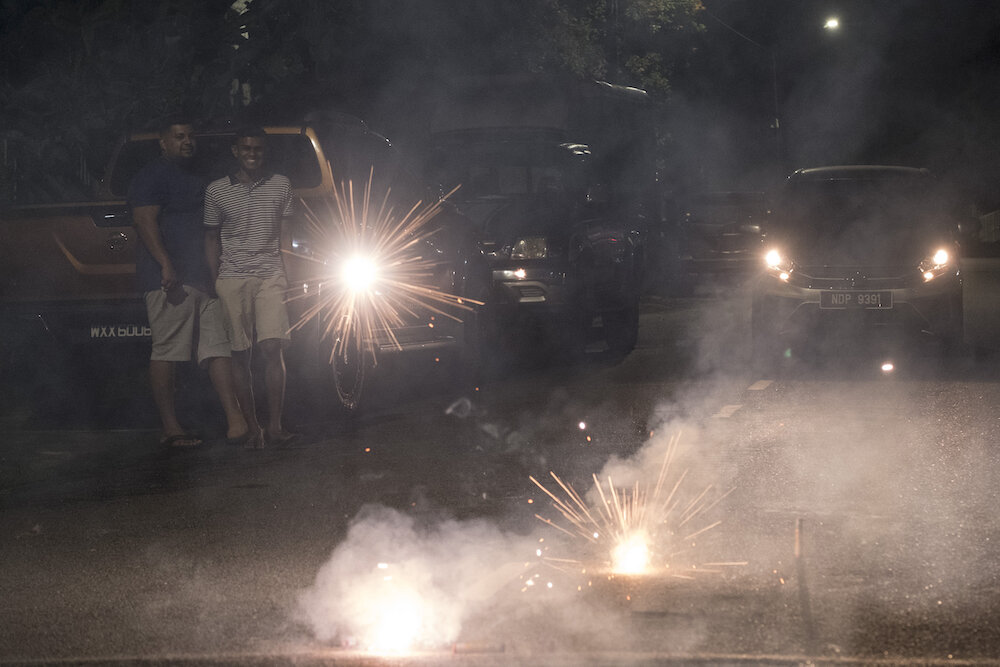  Simon and Sharveen play with firecrackers in front of their uncle’s house in Kuala Lumpur. Fireworks, that mark the beginning of the Diwali celebrations, are one of the must have fun activities. Photo by Alexandra Radu. 