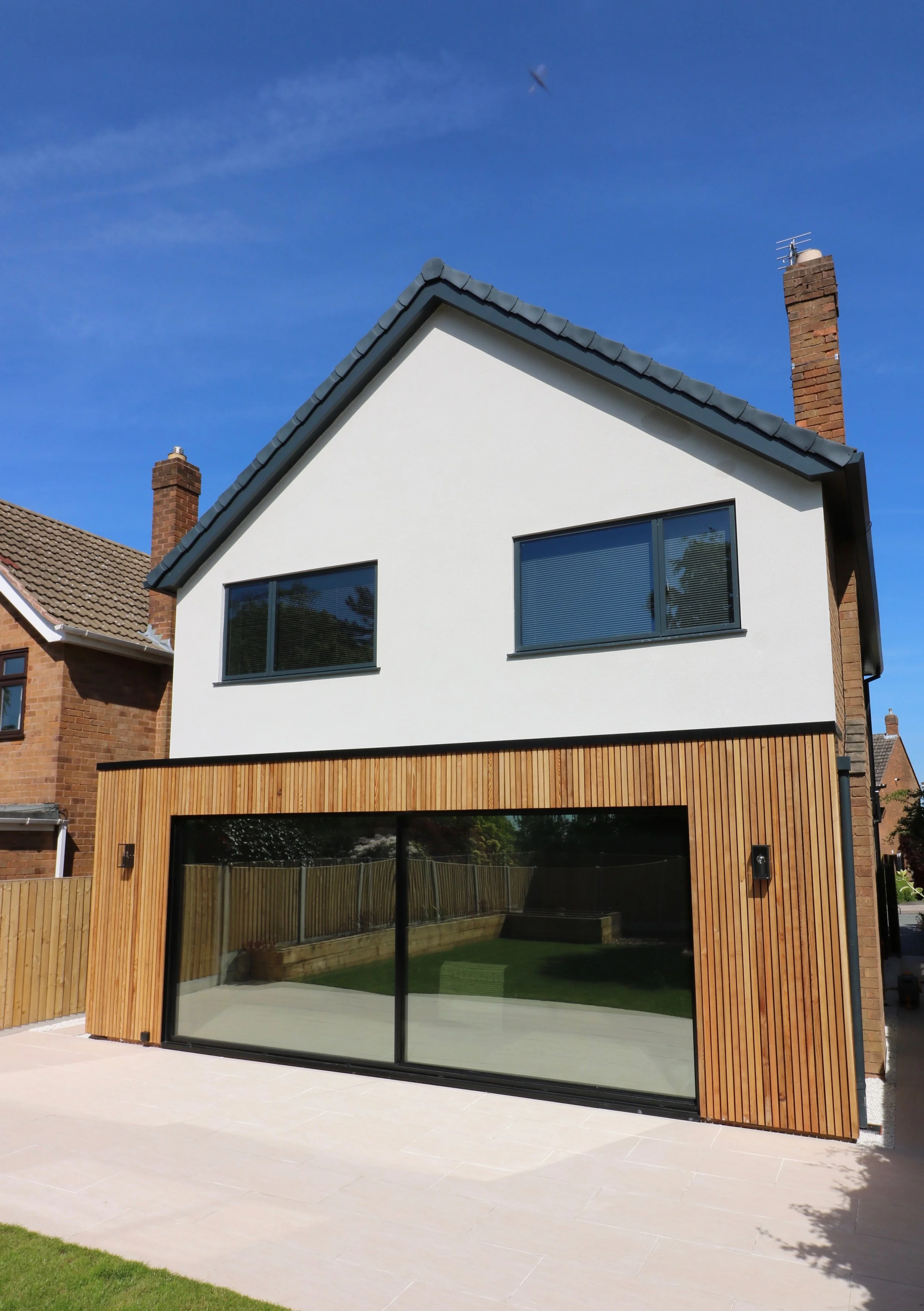 cedar clad rear extension with internal layout alterations and updates to front elevation to property in Penn, Wolverhampton. The result is a crisp, modern external appearance combined with a comforta