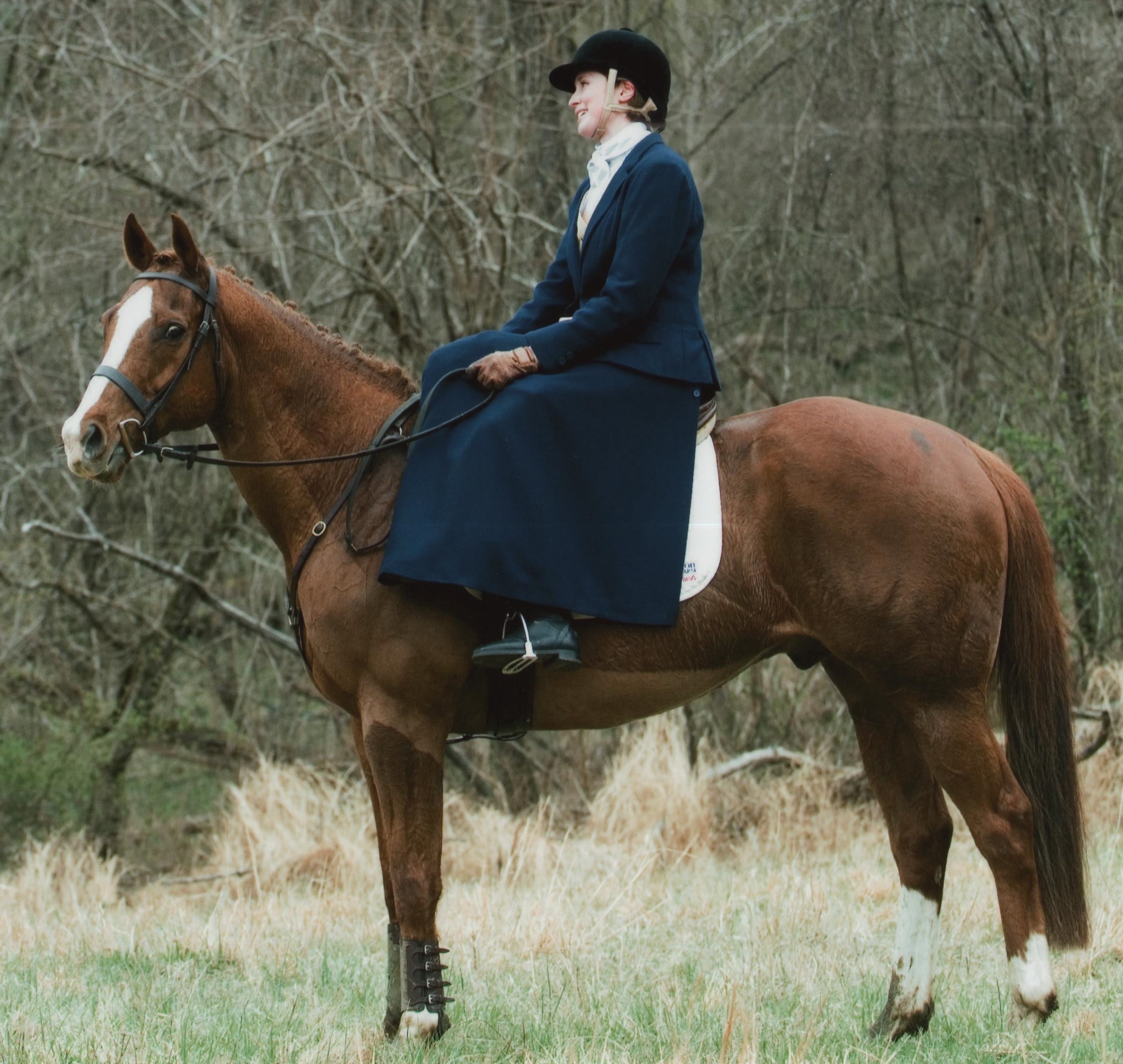 Rider: Aurora Munyan Hometown: Frederick, Maryland Horse: “ Easy To Say No” (Mr. Greeley x. Really Quick), 13 yr old, chestnut TB gelding, owned by Lisa Munyan, bred by Lambs Knoll Farm. “Easy" had six starts and one win before he bowed a tendon and was retired. After being rehabbed for two years, he was given to my mother as an empty-nester project. I was the guinea pig to to start him back under saddle and despite him being a short 15.3hh and me a leggy 5'11", we clicked. I plan on doing a bit of everything with him: he participates in hunter paces, hunts, trail rides, and side saddle races and I'd like to get him into low-level eventing. Easy's personality has really grown since we got him and he can be a ridiculous diva, but he is genuinely sweet and he's got a good sense of humor. He loves foxhunting, a good gallop, meeting new horses, and is especially good at making Hay Tea. Aurora’s Background: I am a Trademark Legal Practice Assistant with Miles & Stockbridge, PC.. I was essentially raised in a barn as my mother, Lisa, was the Manager at the United States Equestrian Team. I've ridden since I was very little, joining the Shenandoah Pony Club when we moved to Maryland. I had a bit of time without a horse of my own but I was fortunate to be able to borrow rides from friends. Riding background: I have ridden since I could sit up and since then I have hunted on and off, participated in shows, hunter-paces, and local Pony Club. Do you Fox hunt?: I have hunted with New Market- Middletown Valley Hounds and have guested with Potomac Hunt and Snickersville Hunt both astride and aside. What got you interested in racing/foxhunting/hunter-pacing aside? I was invited to watch Sarah O'Halloran race at the 2016 Loudoun Point-to-Point and it was thrilling. My mother thought a good birthday present would be a side saddle lesson from Sarah. The lesson was the 2016 Potomac Hunt Fall Hunter Pace and I was hooked. A couple months later I had borrowed a saddle, a habit, and a horse and participated in Potomac Hunt's First Annual Side Saddle Hunt. After a further lesson with Devon Zebrovious, I purchased a gorgeous saddle from her and was all set to join the ranks of the Ladies Who Ride Aside. I've an 'electric arse' according to my mum, so racing was my inevitable next adventure. What are your side saddle goals for 2018? I would like to show Easy under side saddle. Something you might not have known about Aurora: I sew my own habits!