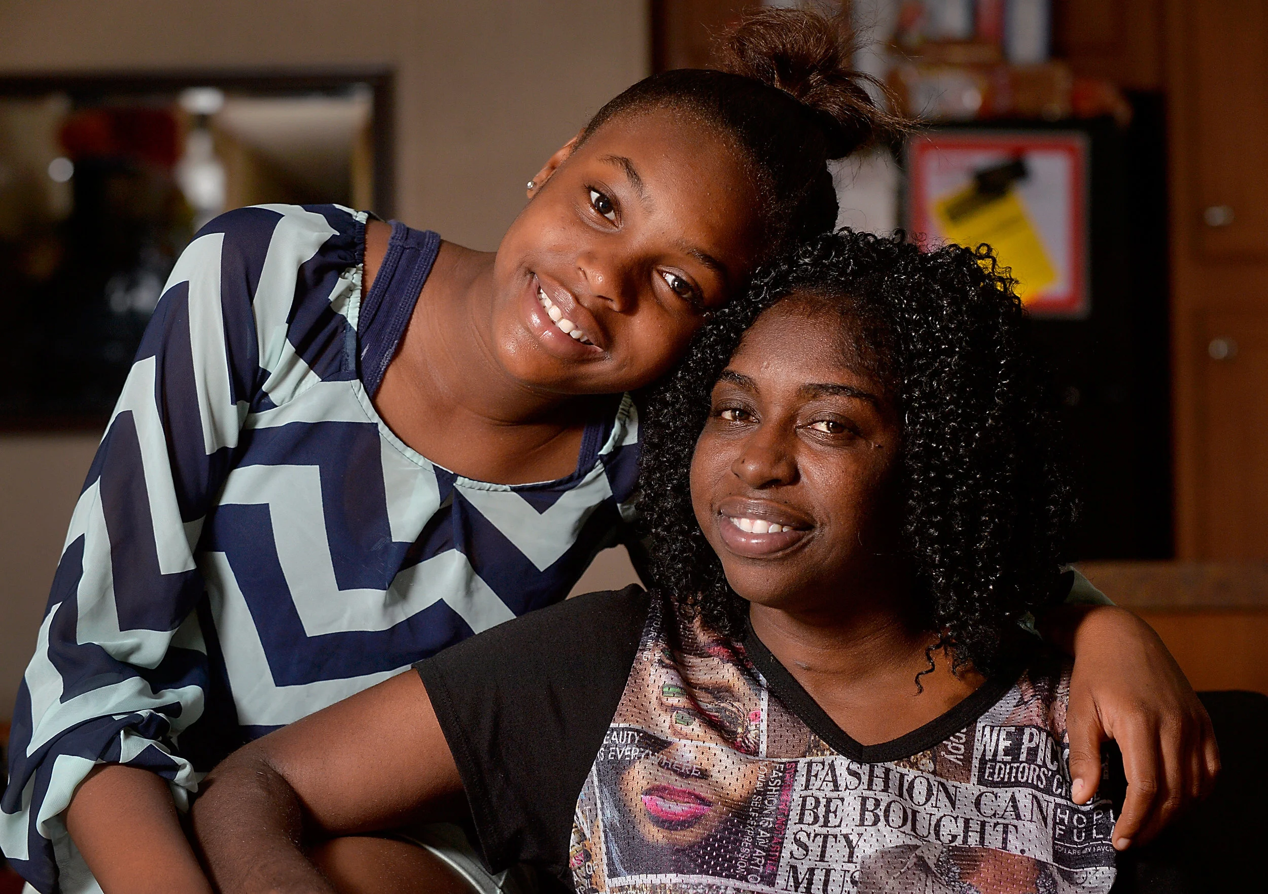 Lateisha Sallah and her daughter Jasmine, 11, in their home in Raleigh, N.C., on Thursday, June 16, 2016. During a health crisis that led to job loss and homelessness, Lateisha's daughter was able to receive the IFFS BackPack Buddies program. IFFS, together with other nonprofits, came together to support her while she got back on her feet.(Photo by Sara D. Davis)