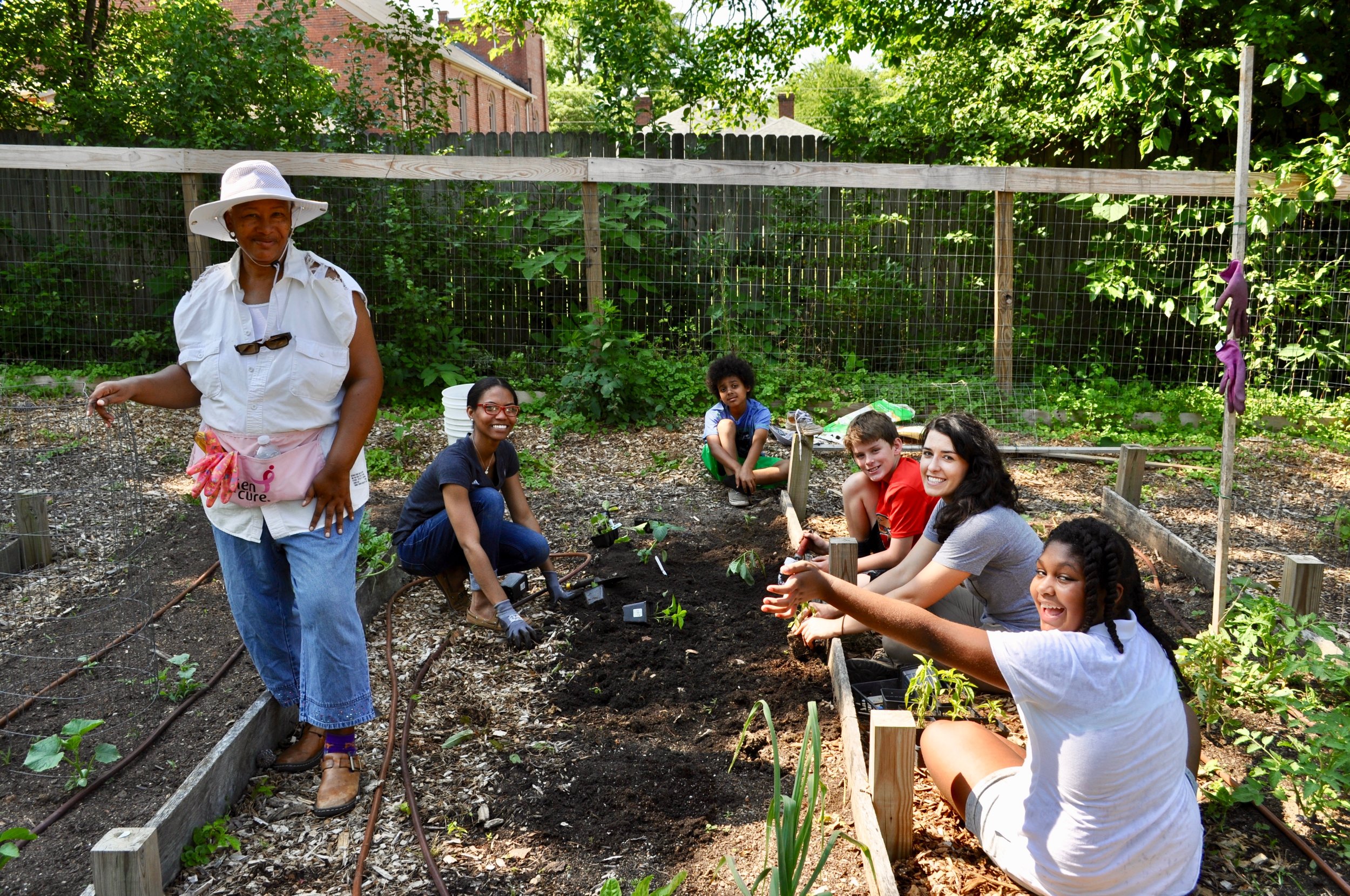 Deborah, a local community member, and Katie Murray with some of the Hunger Heroes students working at the Camden Street Learning Garden.