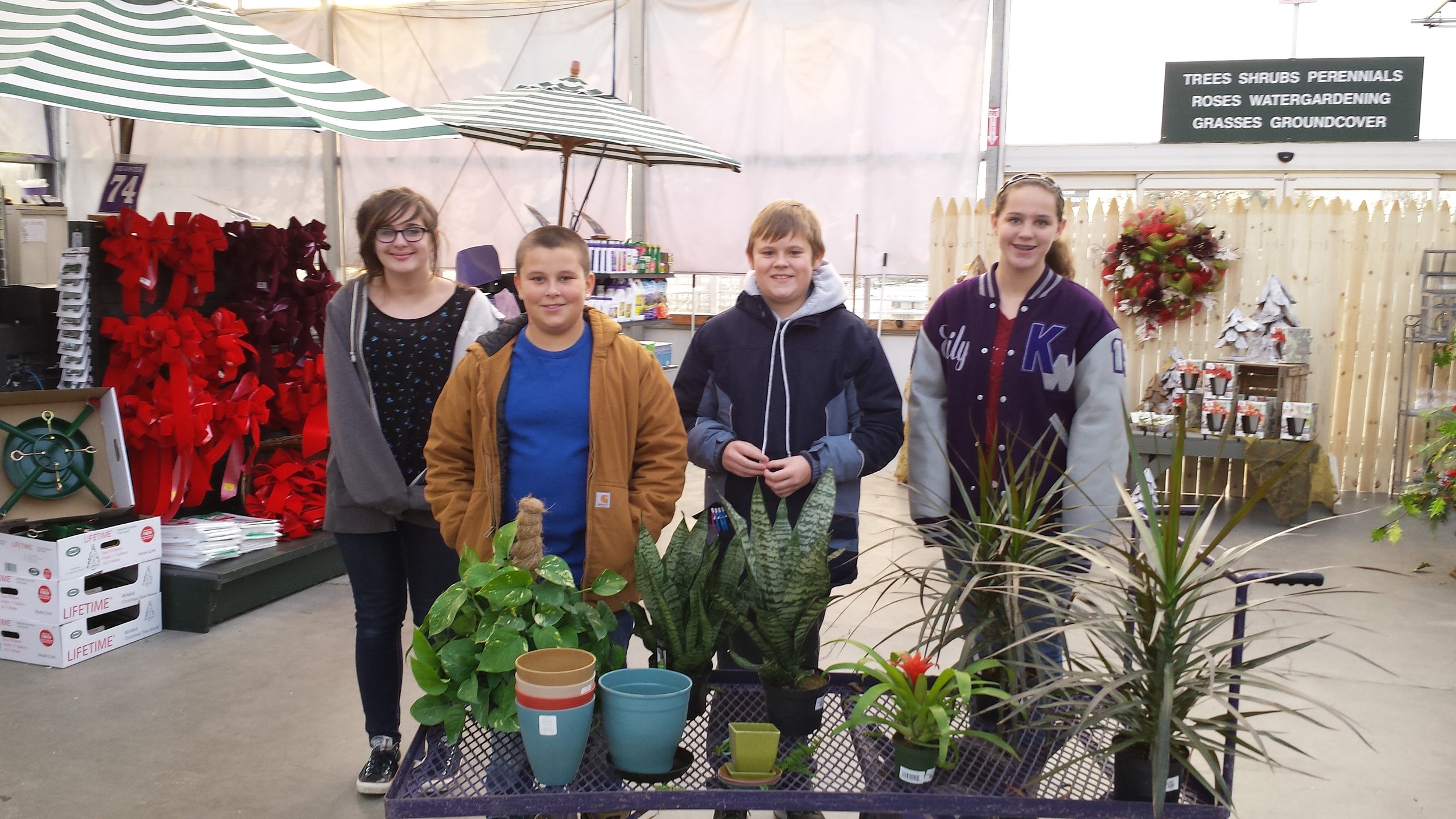 group of students with assorted plants