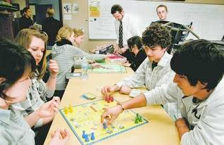 German students socialize with their American student hosts at Kensington Woods High School in Genoa Township. From front left: Carla Volz, Nora Kakonja, Lisa Wilms, Nina Altmann, teacher Markus Muennix, Laura Vallo, Nathan Hinkle, Dan Smith and Dario Banazak. Muennix, a native of Germany, organized the exchange program. (Photo by ALAN WARD/DAILY PRESS & ARGUS)