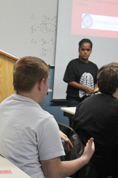 Sophomore CJ Blagborne discusses the effects of genocide with the class and Senior and presenter Deepika Schild.