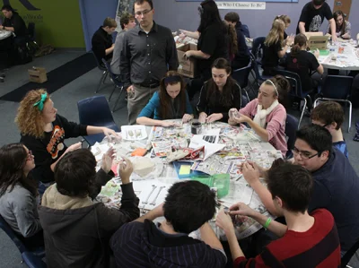 Students working on their bones while talking to teacher Ian Zang.