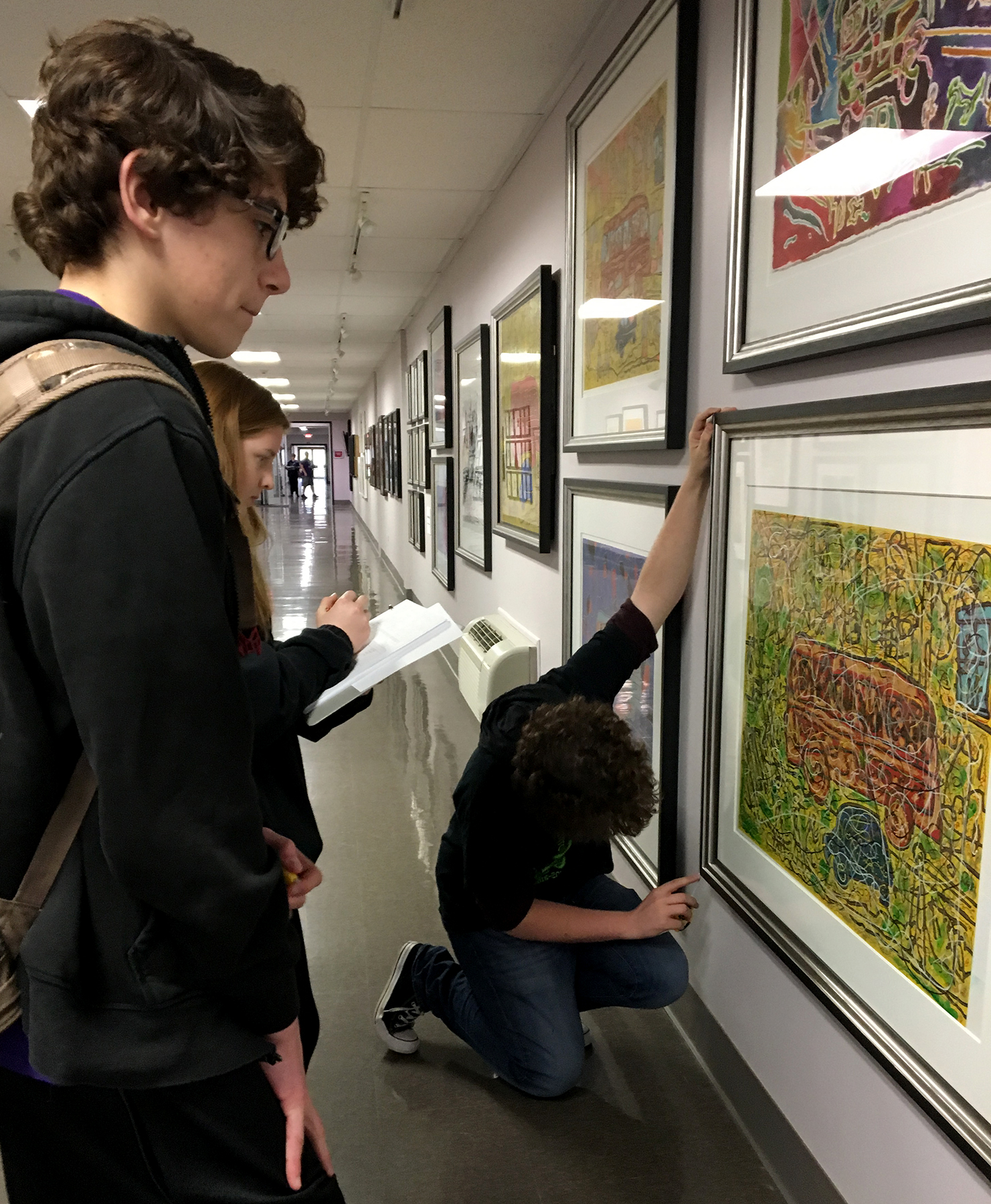 students displaying artwork