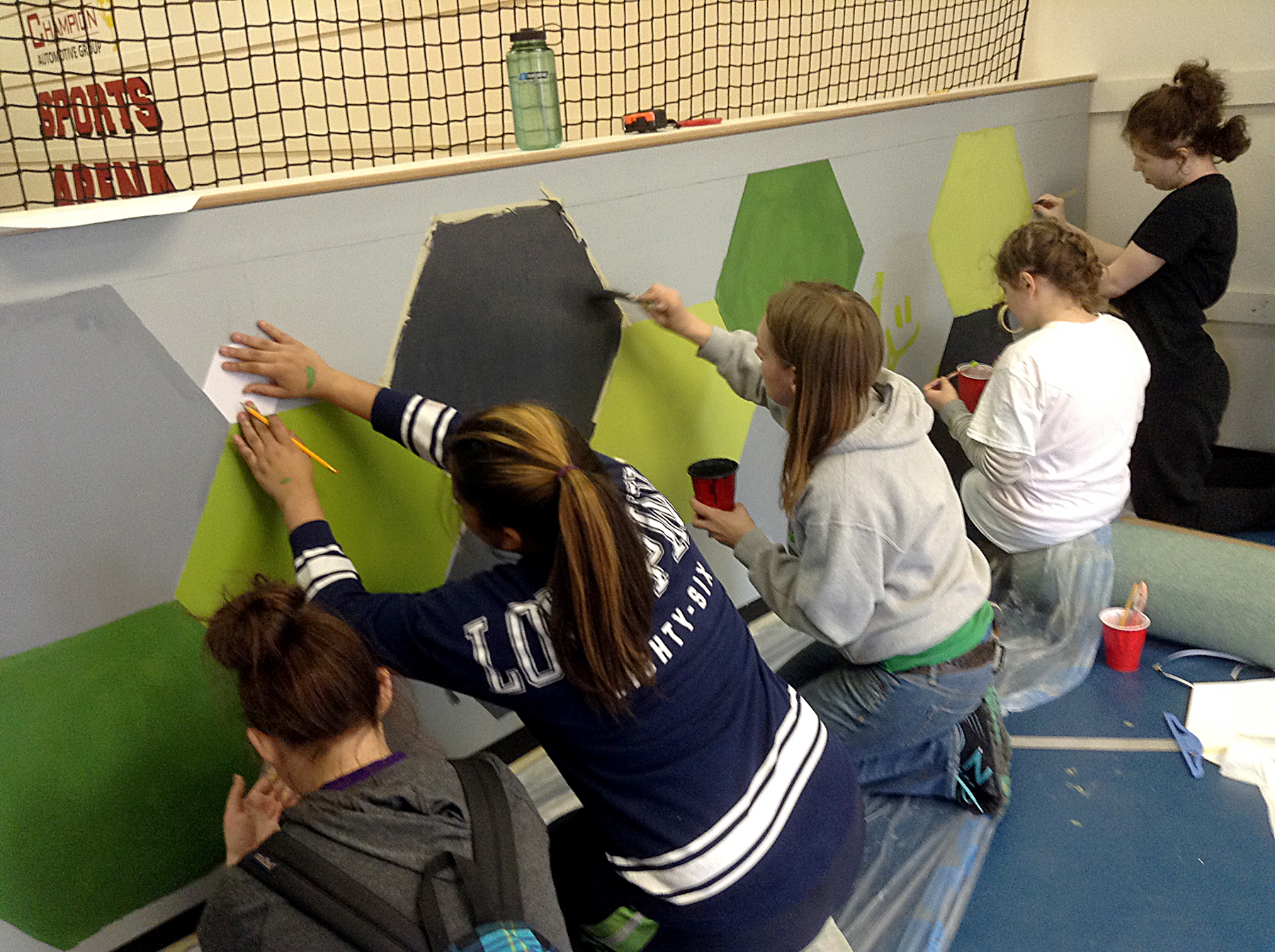 students painting a wall