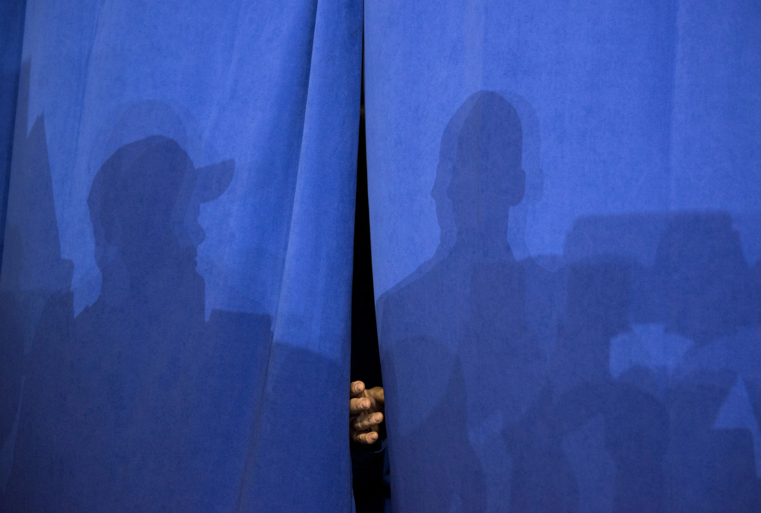 A hand appears through the curtain before Donald J. Trump walks onto the stage the Delaware County Fairgrounds during a campaign rally at the Deleware County Fairgrounds on October 20, 2016 in Delaware, Ohio.
