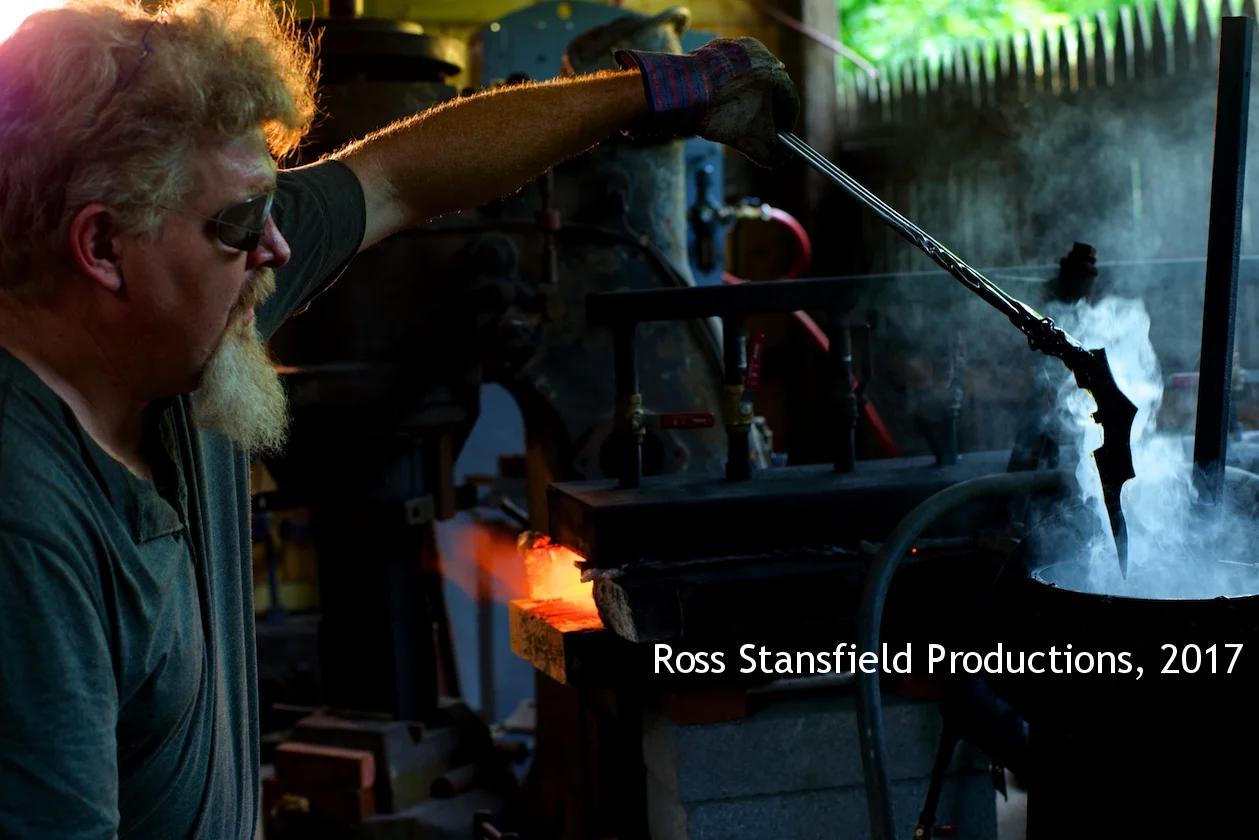 Kerry lifts Bat Man's emblem from cooling vat