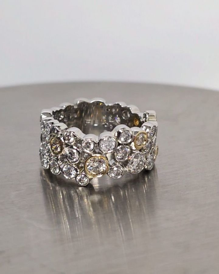 Platinum and yellow gold mixed sized diamond "Bubble" band. 
This was a fun project, taking all of my clients old, unworn items apart and redesigning them into a modern wearable piece of art. It came together very organically. 

#diamondban