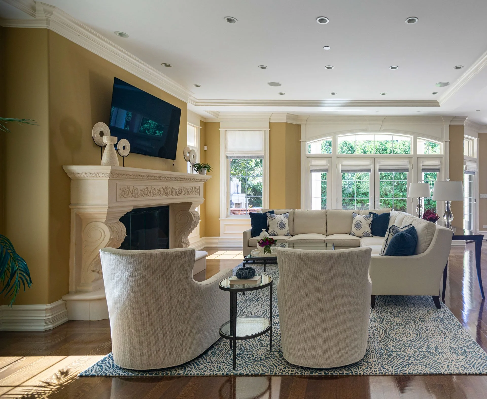 Lincolnwood IL family room with sectional sofa fireplace and tall windows designed by Wendy Nobriga Interiors