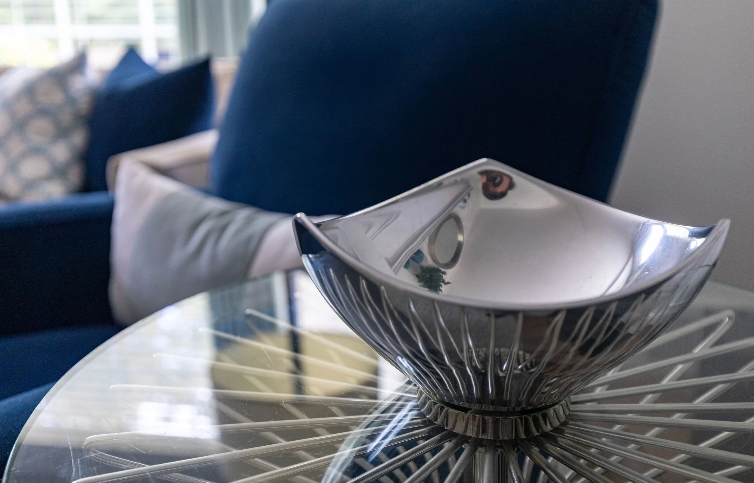 Living room styling detail in Edgebrook, Chicago, IL with modern side table, sculptural glass bowl, and layered seating. Design by Wendy Nobriga Interiors.