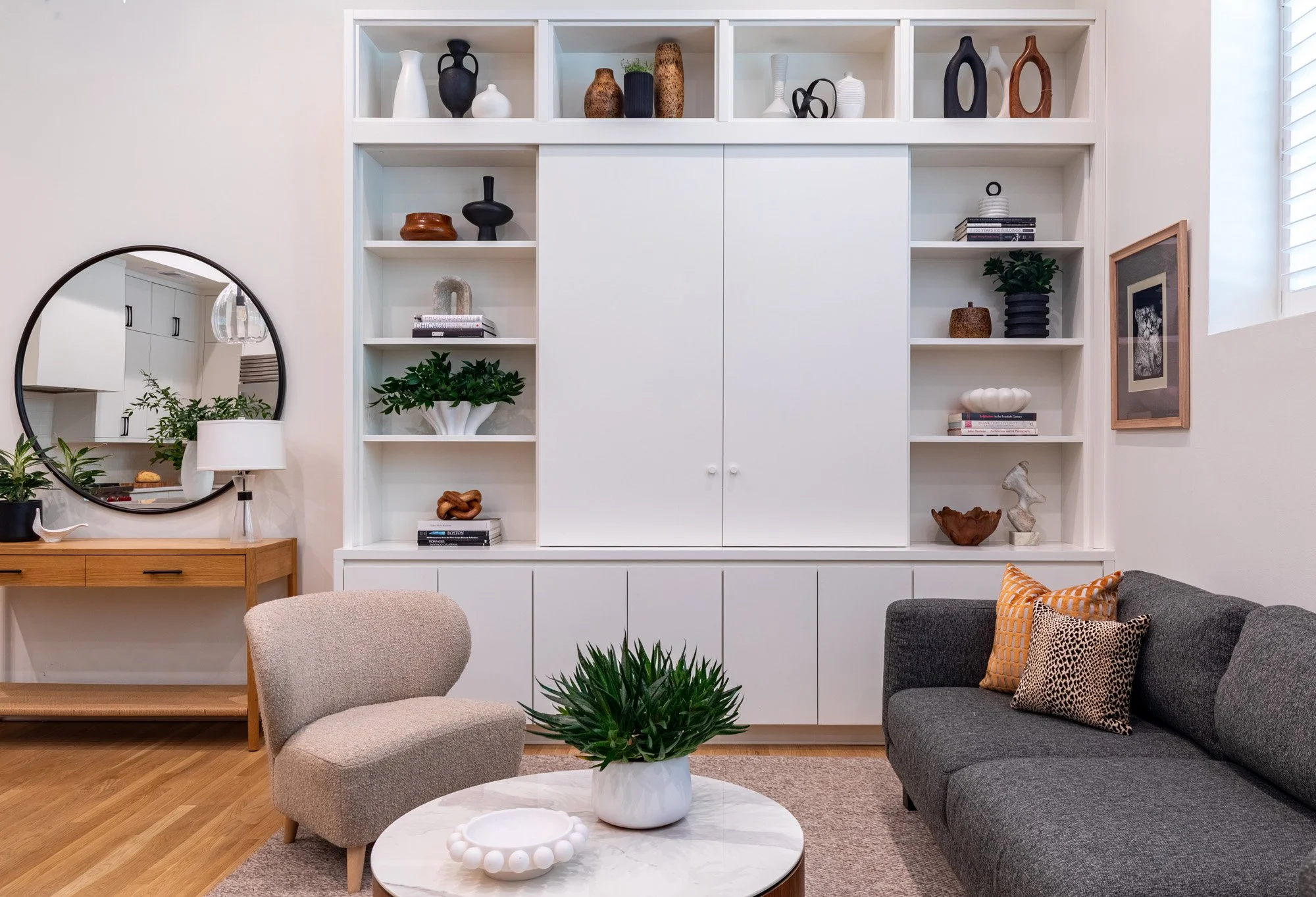 Lincoln Park, Chicago modern living room designed by Wendy Nobriga Interiors featuring a custom media wall, comfortable seating, and a warm, inviting open-concept design.