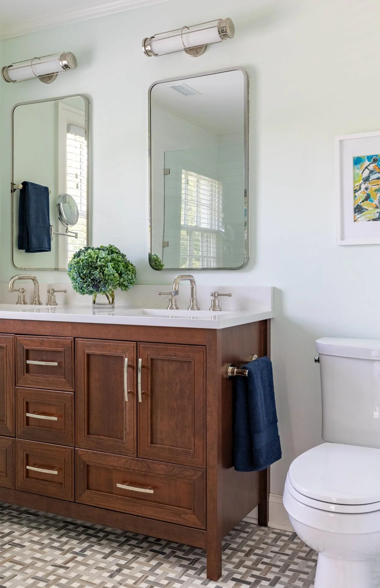 Lake Forest IL primary bathroom with double vanity, wood cabinetry, quartz countertop, and polished nickel fixtures, designed by Wendy Nobriga Interiors.