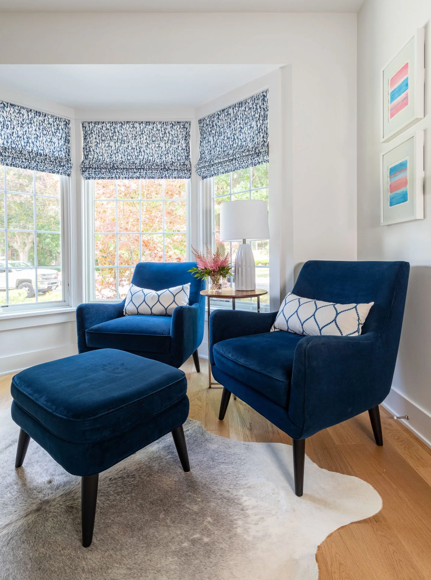 Wildwood Chicago IL home office bay window seating with navy armchairs, ottoman, and accent table designed by Wendy Nobriga Interiors.