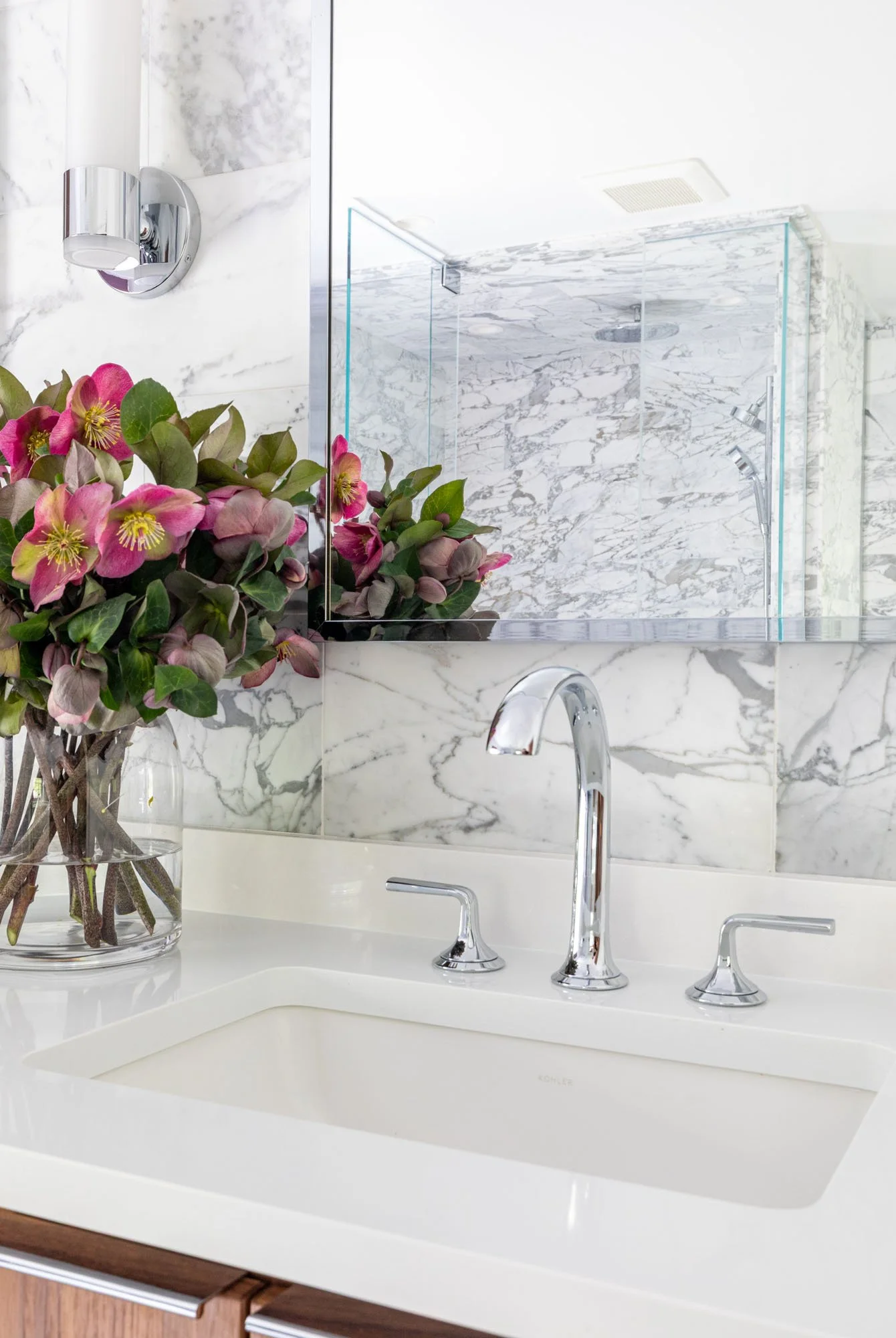 Primary bathroom sink and faucet detail in Northbrook, Illinois with marble countertop. Design by Wendy Nobriga Interiors.