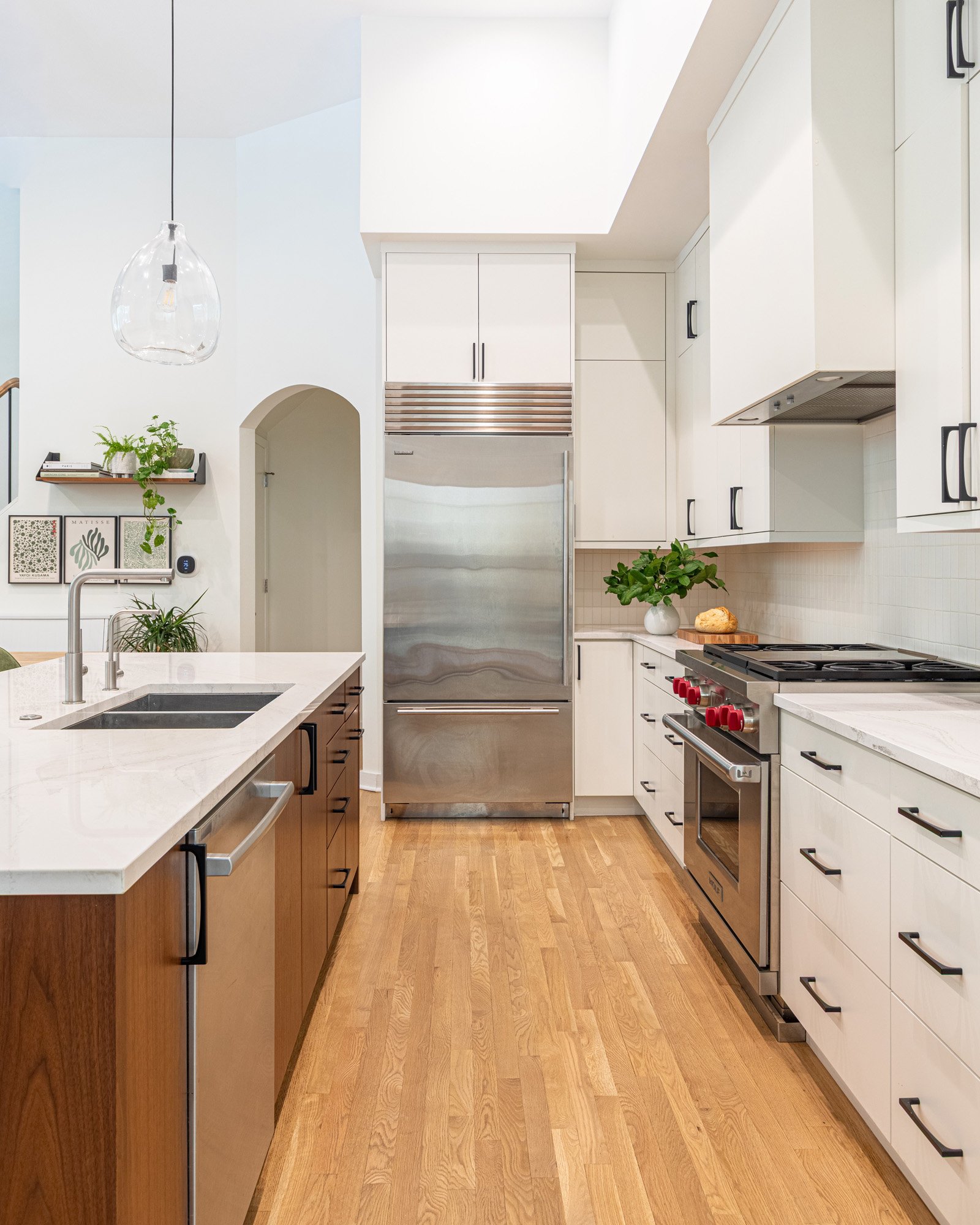 Lincoln Park, Chicago galley kitchen designed by Wendy Nobriga Interiors featuring custom cabinetry, professional-grade appliances, and a functional layout.