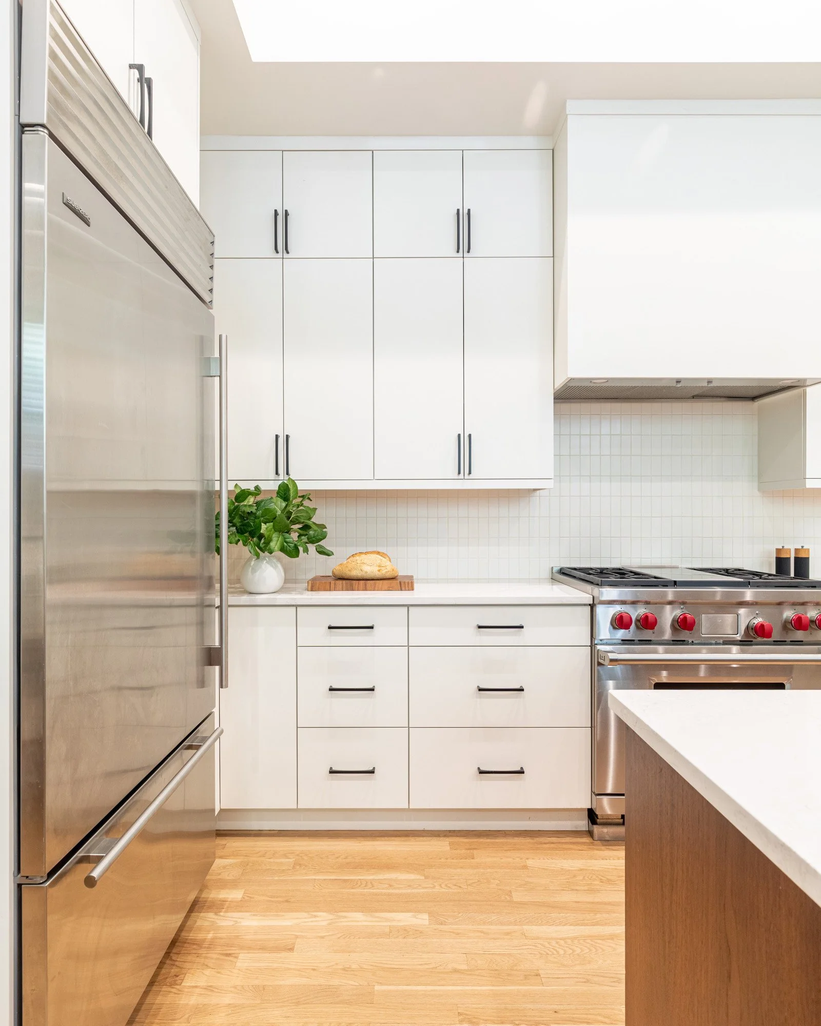 Lincoln Park, Chicago modern kitchen range wall designed by Wendy Nobriga Interiors with custom cabinetry, integrated storage, and a streamlined aesthetic.