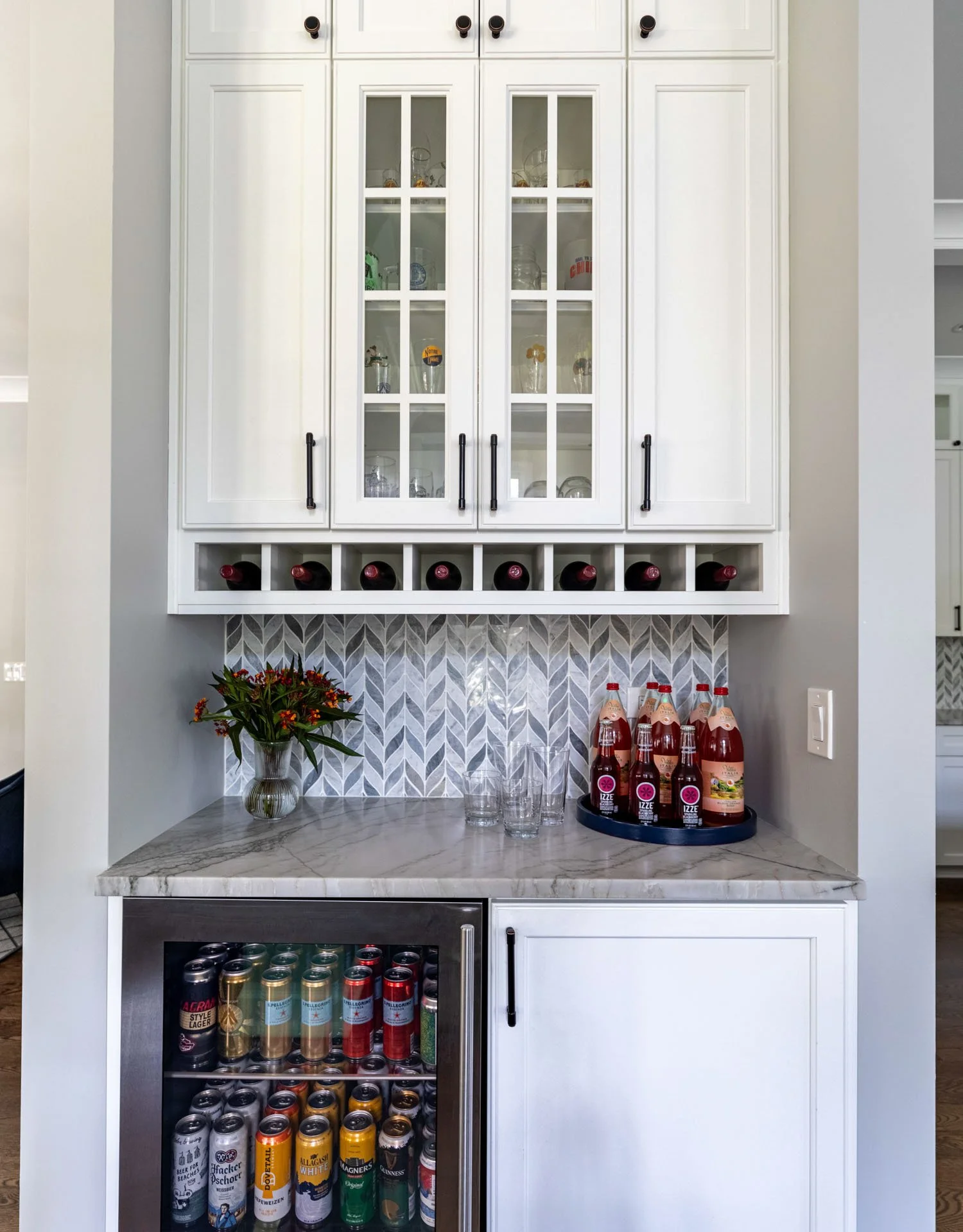 La Grange IL kitchen beverage center with quartzite countertop, wine storage, beverage fridge, and glass cabinetry by Wendy Nobriga Interiors.