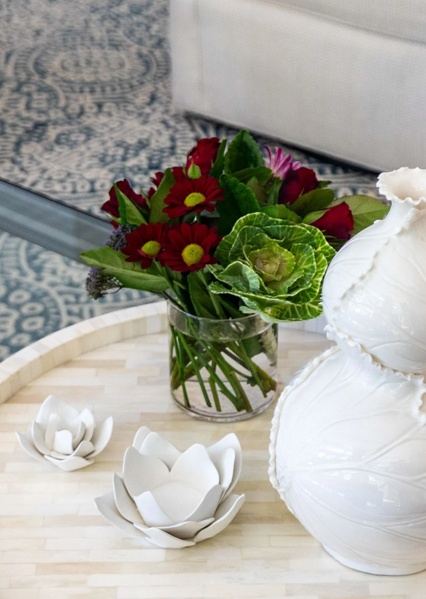 Lincolnwood IL family room coffee table with white vase lotus candle holders and floral arrangement designed by Wendy Nobriga Interiors