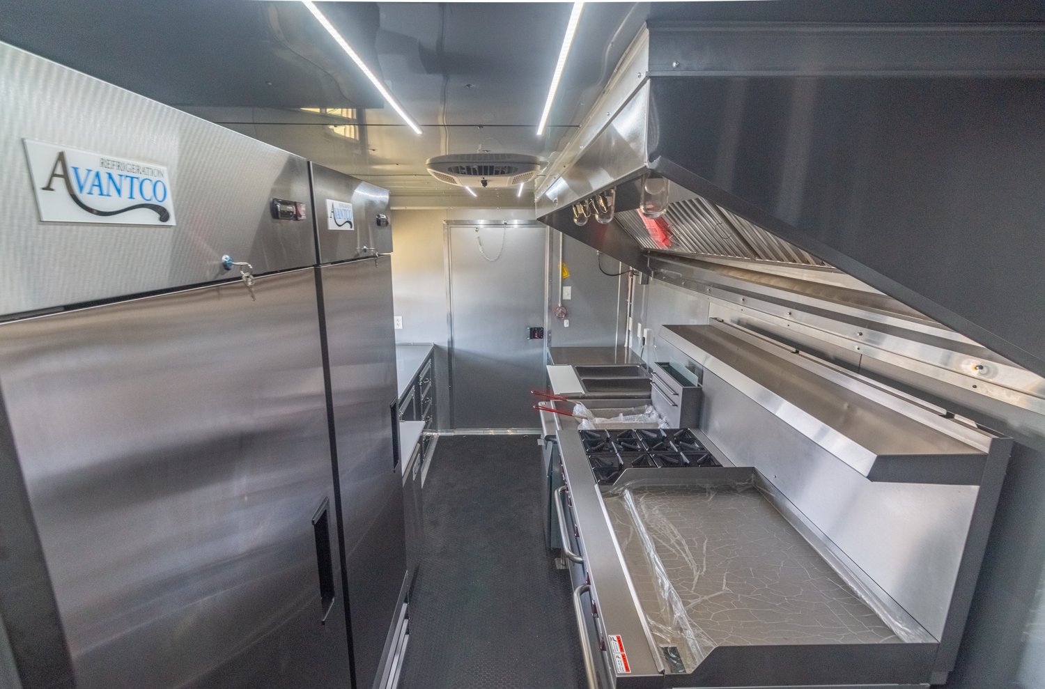 Custom Trailer Pros - black food trailer with large porch on rear Vin 82878-38.jpg