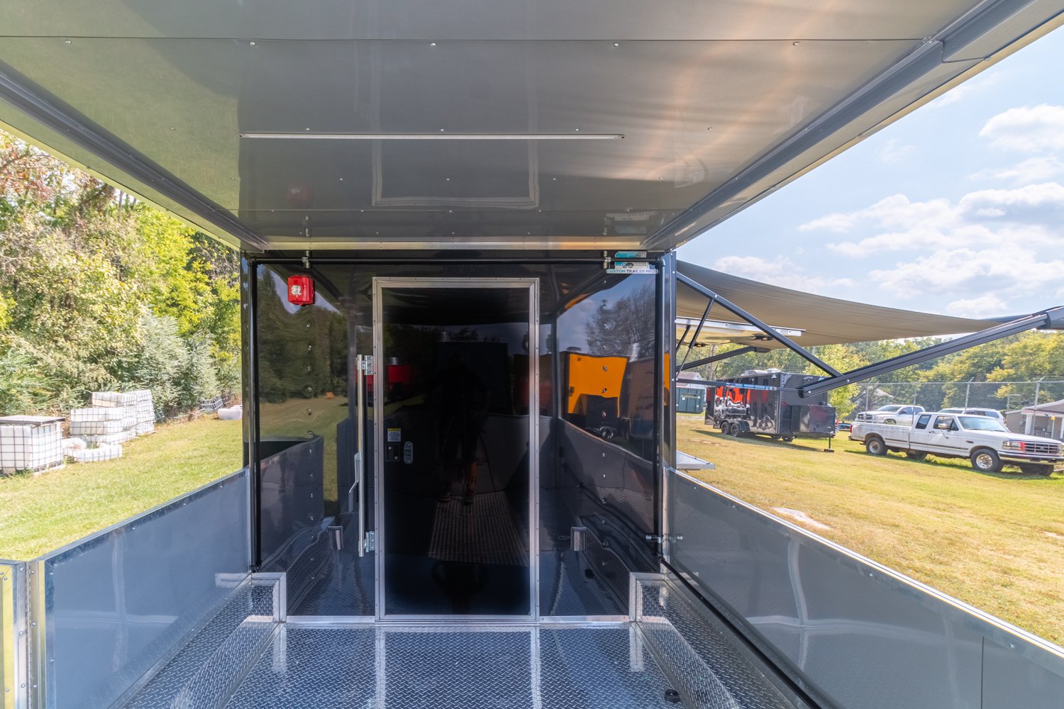 Custom Trailer Pros - black food trailer with large porch on rear Vin 82878-11.jpg
