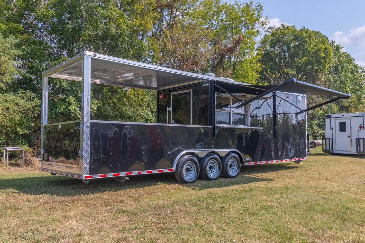 Custom Trailer Pros - black food trailer with large porch on rear Vin 82878-1.jpg