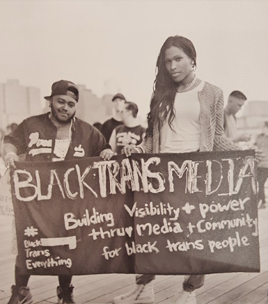 Sasha and Olympia with banner.png