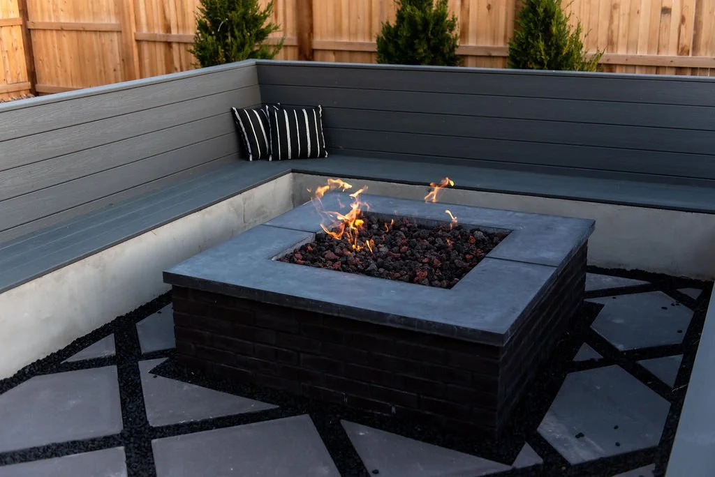 dark stone fire pit with custom bench seating