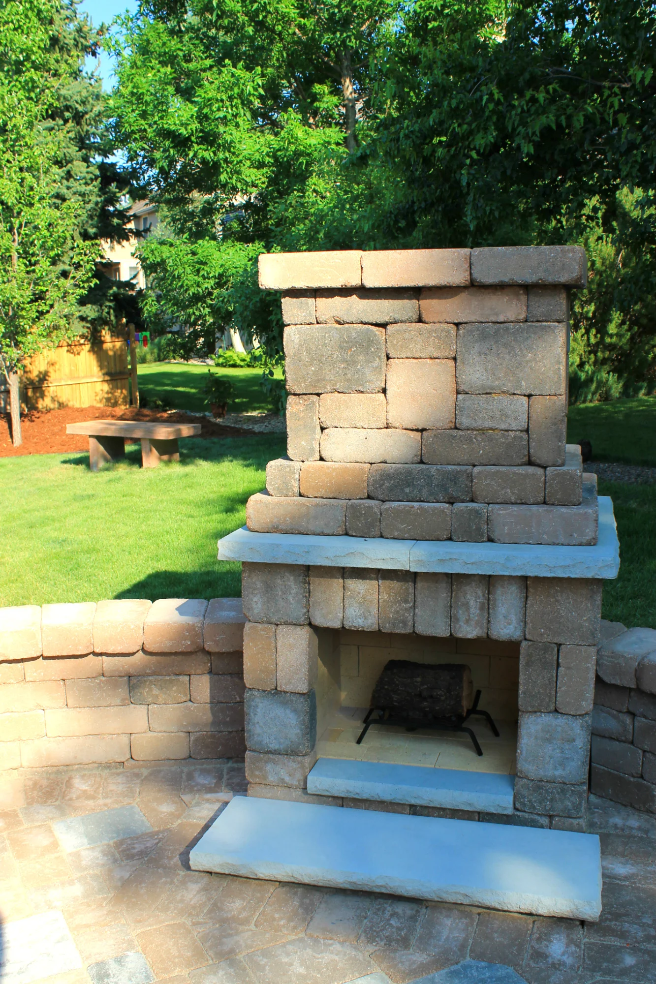 custom paver patio with outdoor fireplace