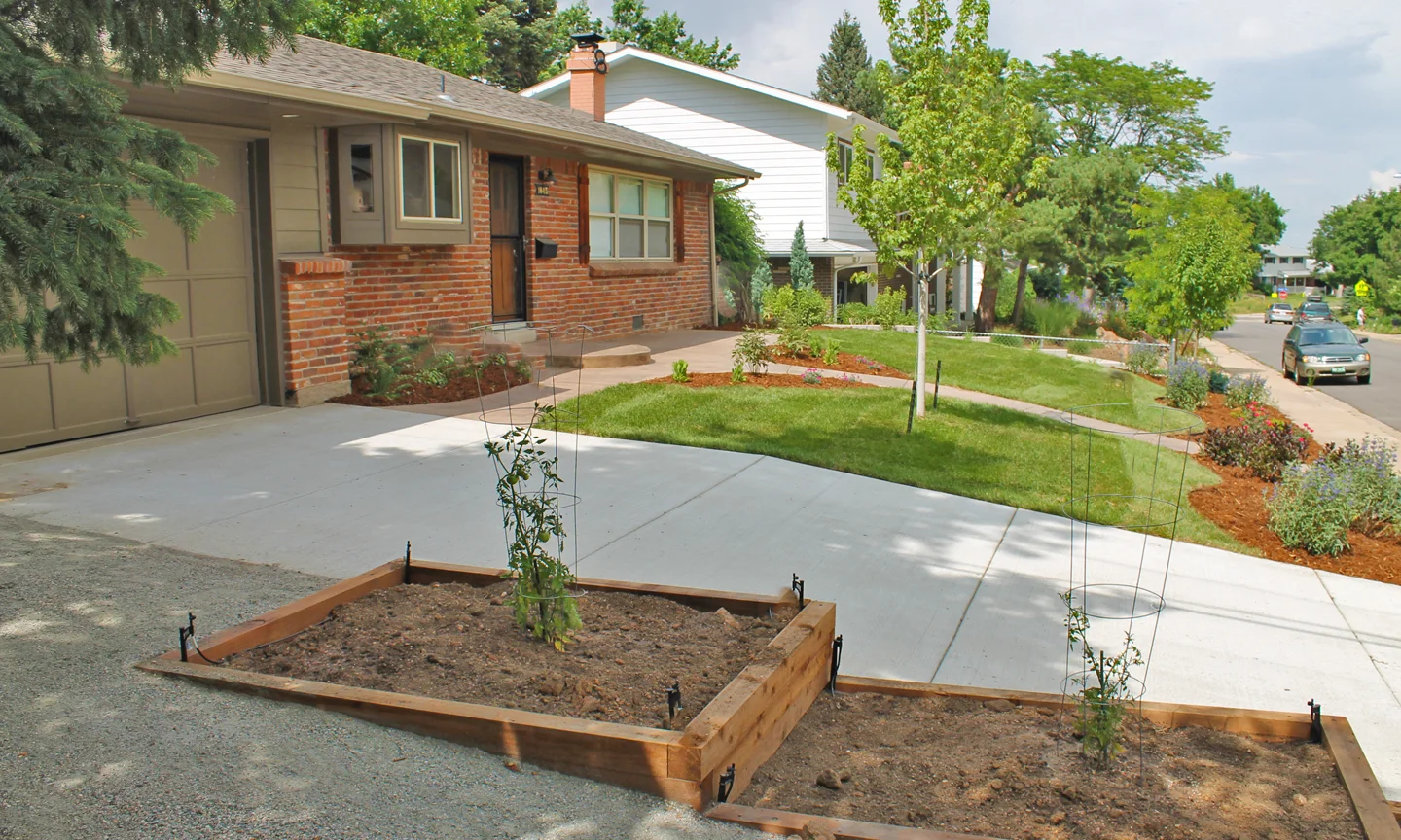 multi level cedar plant boxes next to driveway