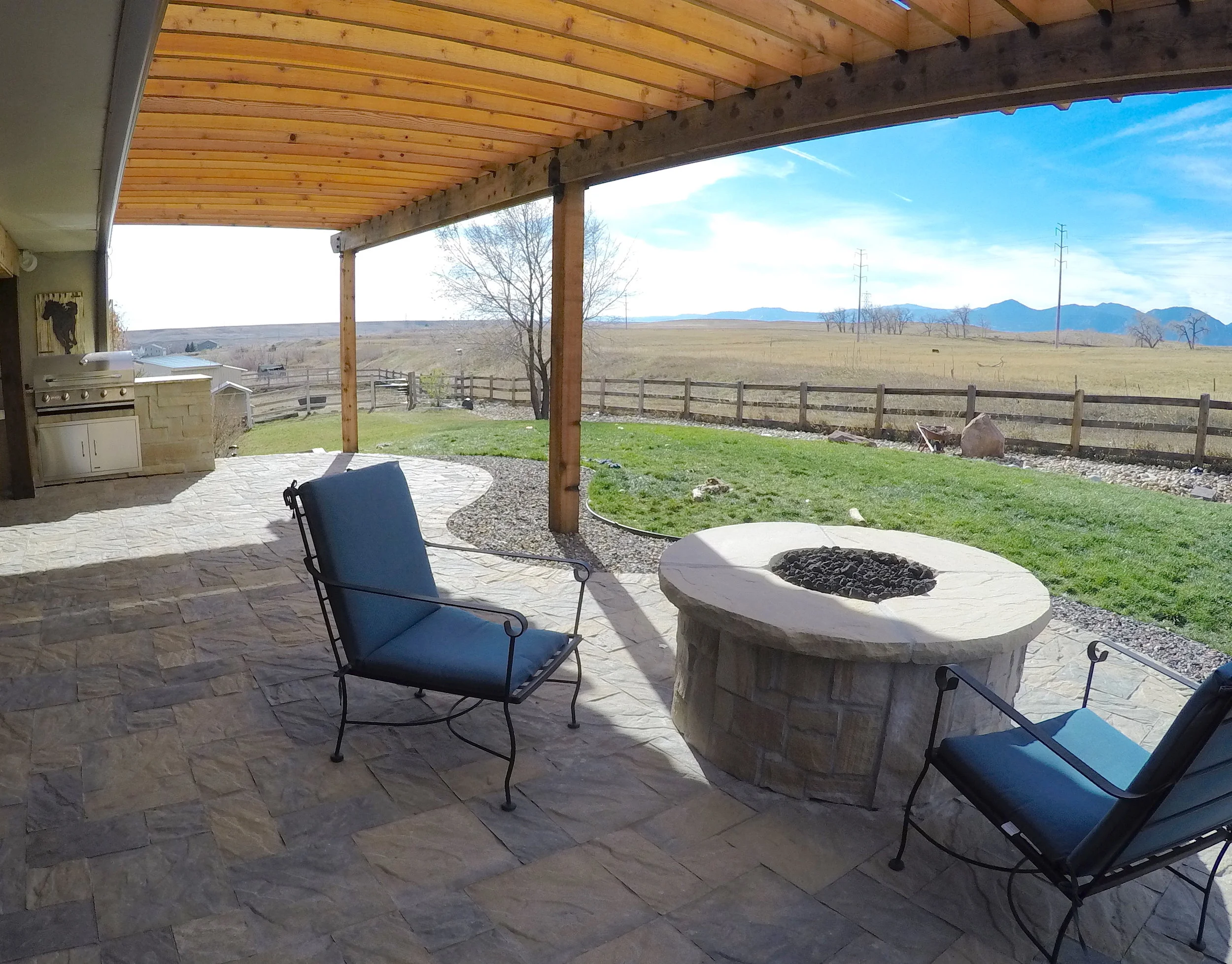 custom stone patio with circle fire pit