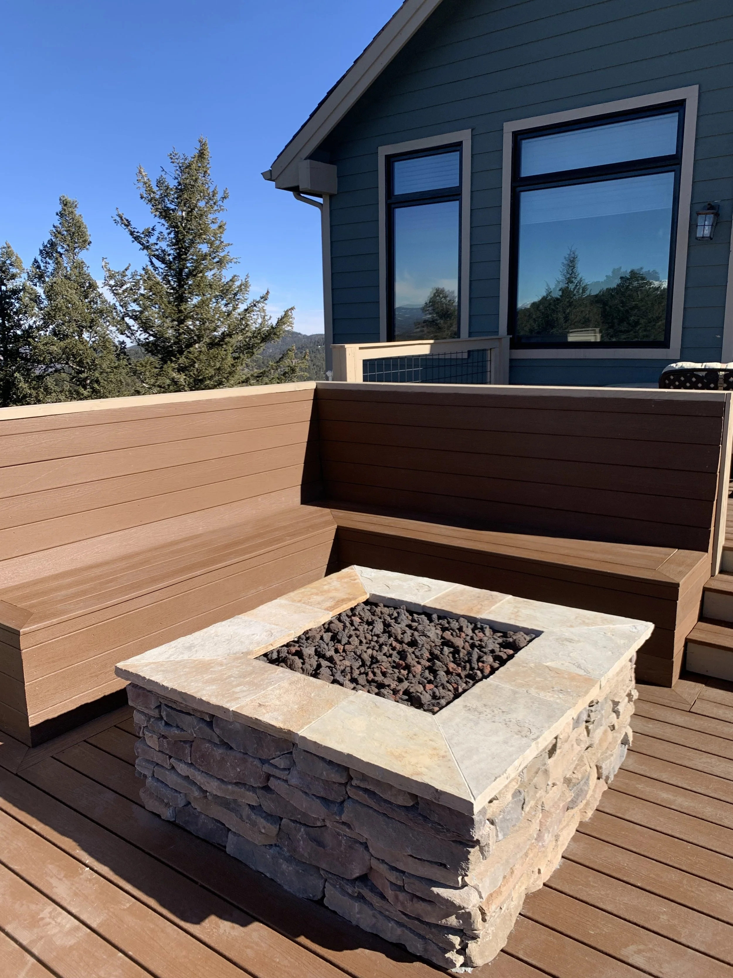 Custom square fire pit on deck with seatwall