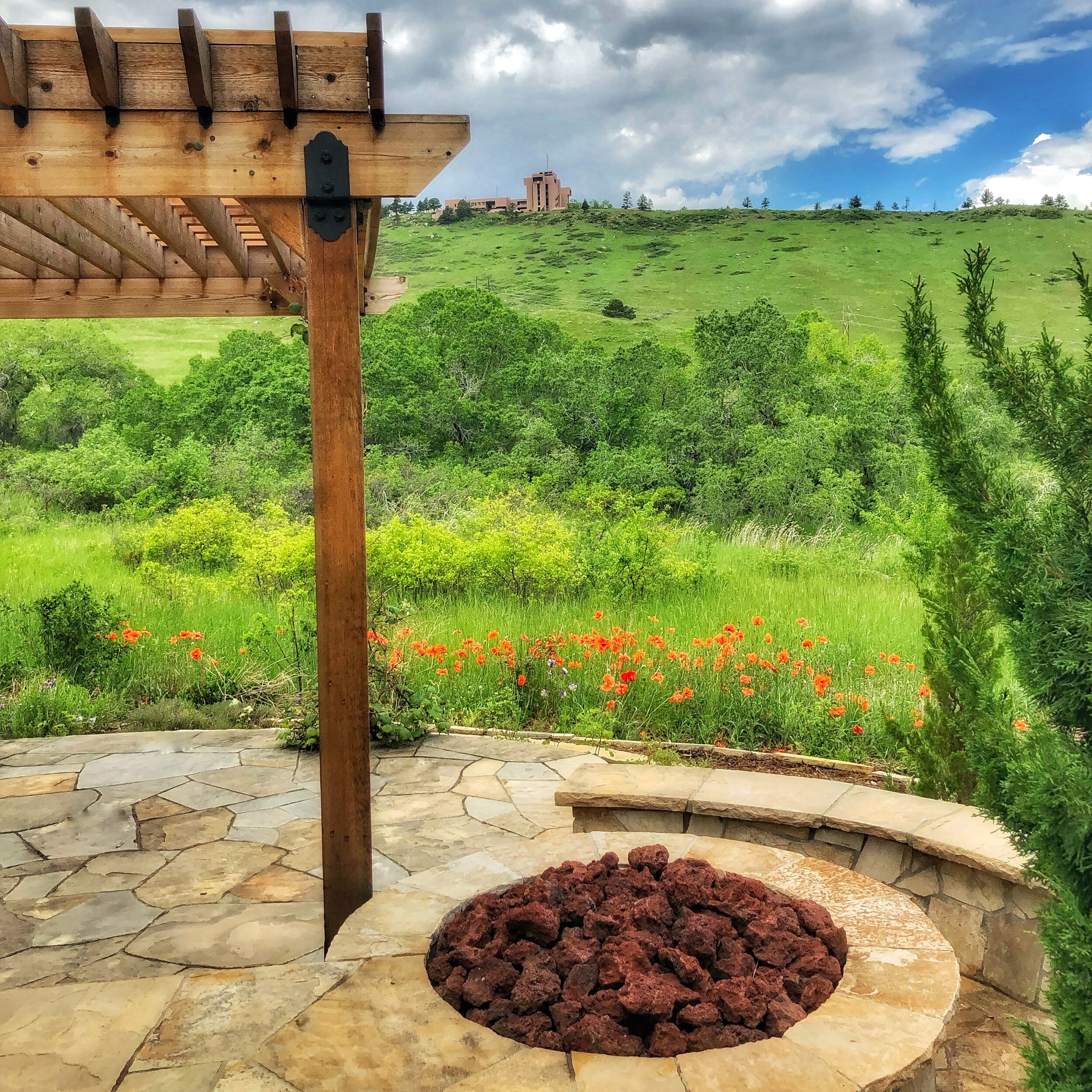 natural flagstone patio with fire pit and cedar pergola